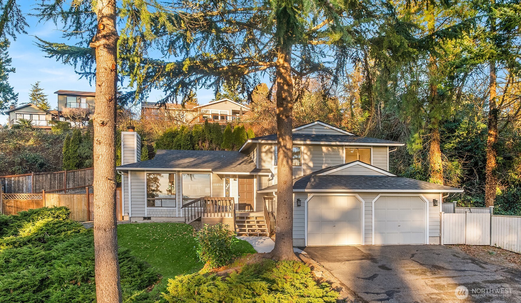 Beautifully remodeled home with partial lake, mountain, and city views in the desirable Juanita Point neighborhood of Kirkland. This inviting 3-bedroom, 2.25-bath tri-level is perched on a private lot surrounded by mature landscaping. Recent updates include a new roof, fresh interior paint and new flooring throughout most of the home. Completely renovated kitchen and baths include new cabinets, countertops and modern lighting. The sunlit great room creates a welcoming space for everyday living and entertaining. The spacious primary bedroom features a luxurious ensuite bath. Two additional bedrooms and a full bath are conveniently located on the same level. The lower level offers a powder bath, laundry area, and large family room - ideal for bonus, media or play space. Enjoy move-in-ready comfort with no HOA, excellent Lake Washington Schools, and a prime location just minutes to Juanita Shopping Center and Juanita Beach Park. Easy access to downtown Kirkland, Bellevue, and Redmond. Oversized lot offers potential for boat or RV parking.