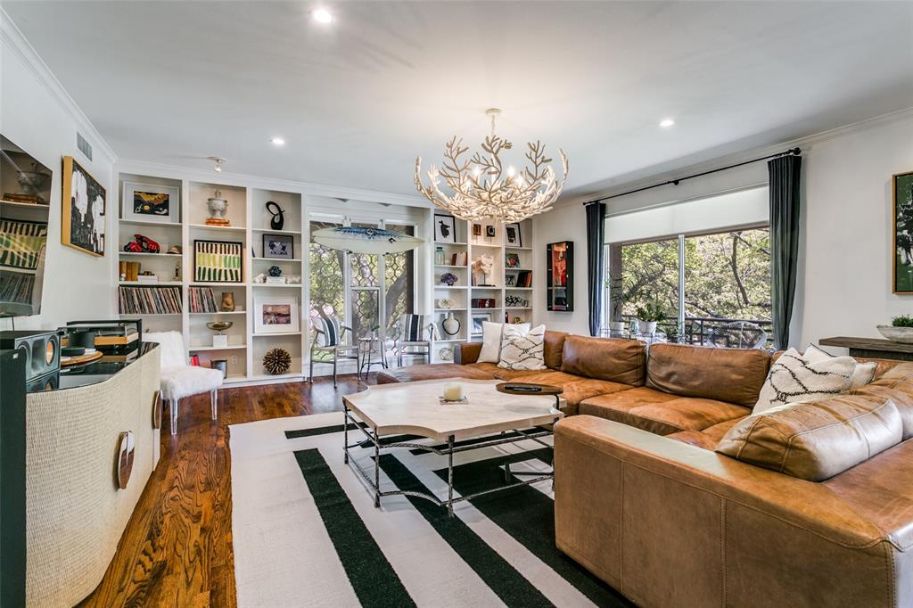 Tucked in the heart of Preston Hollow, 6332 Bandera APT D offers a rare blend of tranquility and convenience near Preston Center and the Park Cities. This fully remodeled, second-story residence lives like a private retreat, surrounded by mature oak trees and filled with natural light. A mudroom-style entry opens to a spacious living area with custom shelving, a powder bath, and serene tree views. Two expansive 40-foot balconies create a true indoor-outdoor feel. The kitchen and dining flow seamlessly with an oversized island, walk-in pantry, and ample storage.The primary suite features peaceful tree views, dual vanities, a soaking tub, separate shower, and two walk-in closets. The secondary bedroom includes an en-suite bath and generous storage, ideal for guests or a home office.Smart home features include security, thermostat control, and electric blinds. Washer, dryer, and refrigerator are included. The HOA covers all utilities except WiFi, along with exterior maintenance and a community pool. Two covered parking spaces included.