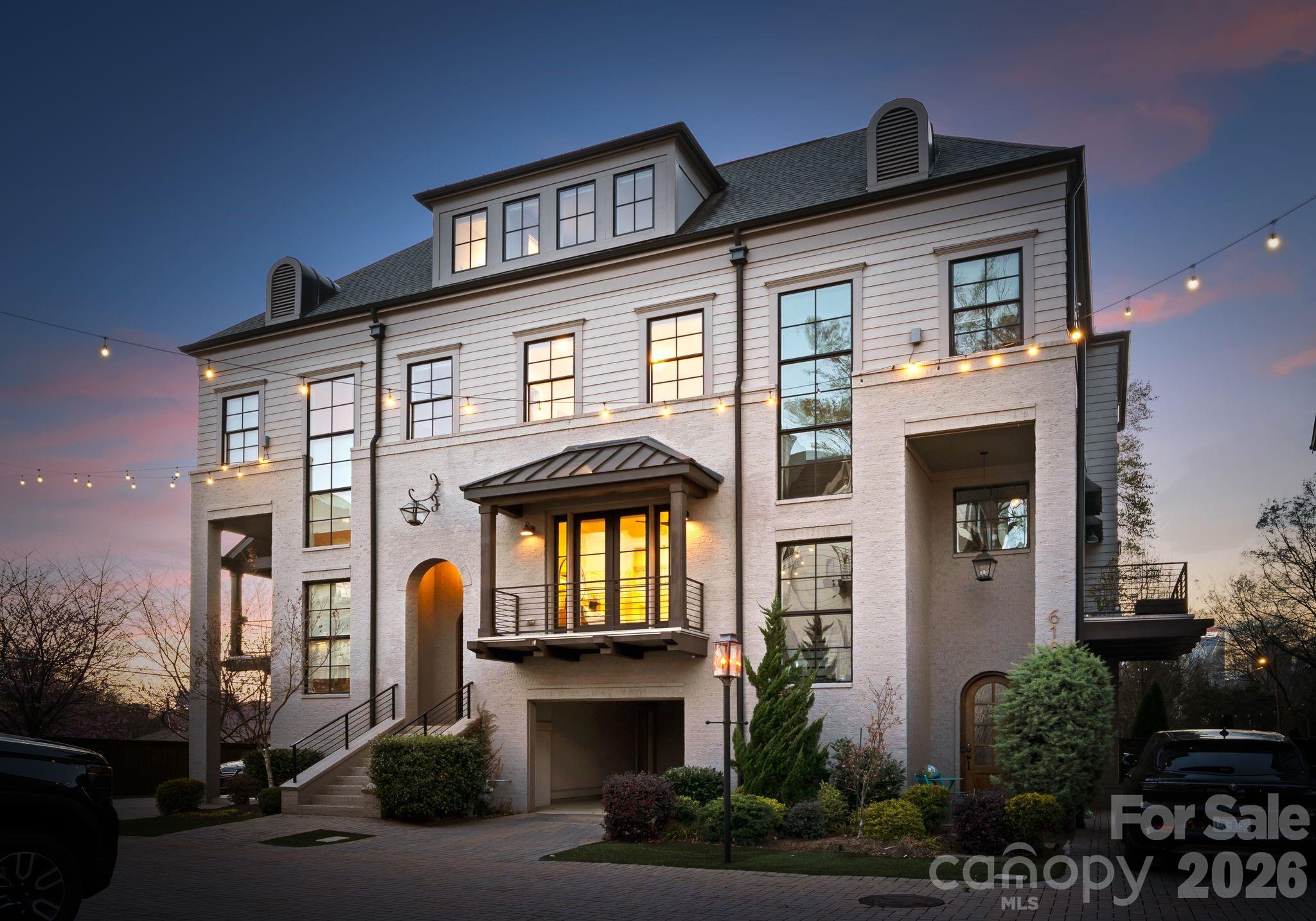 Located in the highly sought-after Towers at Mattie Rose in Charlotte’s historic Elizabeth neighborhood, this exceptional four-story townhome by Grandfather Homes pairs timeless Dutch-inspired architecture with refined, design-forward interiors. Defined by its striking brick-and-fiber-cement exterior, oversized windows, and thoughtfully curated finishes throughout, the home offers a rare blend of urban sophistication and warm, livable elegance. Inside, the residence is filled with natural light and elevated by pre-finished wood flooring, detailed trim work, designer tile, quartz surfaces, and a beautifully appointed chef’s kitchen featuring a large center island, custom cabinetry, and high-end appliances including a gas range, gas oven, microwave, refrigerator, dishwasher, disposal, and exhaust hood. The main living spaces are open yet intimate, creating an effortless flow for both everyday living and entertaining. The spacious primary suite serves as a true retreat, complete with a walk-in closet and private bath, while the additional bedrooms are generously sized and offer excellent flexibility for guests, office space, or multigenerational living. A third-level bonus/flex space with a full bath provides even more versatility and could function beautifully as a media room, guest suite, secondary lounge, or private workspace. The lower level adds another bedroom and full bath, making the floor plan especially functional for today’s lifestyle needs. Outdoor living is equally compelling, with a private rear yard designed for low-maintenance enjoyment, featuring paver hardscaping and turf landscaping—ideal for morning coffee, entertaining, or a lock-and-leave lifestyle. The home also offers two parking spaces, including an attached garage and attached carport, along with the convenience of a privately maintained street. Homes in this community are prewired for smart home capability, and the setting itself is one of the neighborhood’s most distinctive features: a private paver woonerf, or shared green living street, designed to create a more pedestrian-friendly and visually elevated environment. Positioned just moments from Elizabeth’s beloved restaurants, shops, parks, and greenway access, and with convenient proximity to Uptown Charlotte, hospitals, and the future light rail extension, this home offers a truly exceptional in-town lifestyle.