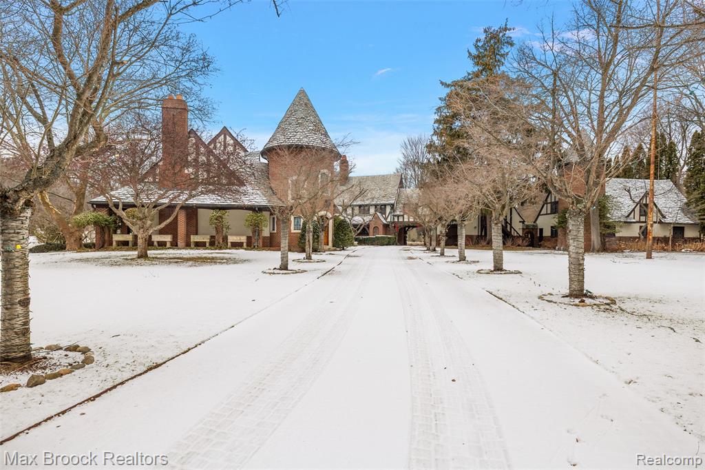 There are homes that impress, and then there are estates that transcend time. Inspired by the regal architecture of Europe’s grandest castles, this extraordinary Bloomfield Hills estate offers a rare fusion of history, artistry, and unmatched privacy on over eight breathtaking acres. This one-of-a-kind residence offers unrivaled seclusion, elegance, and architectural splendor. Surrounded by mature trees, manicured gardens, and expansive green lawns, the property evokes the tranquility of a private sanctuary. From the moment you arrive, the home’s old-world craftsmanship is on full display, featuring intricate millwork, hand-carved wood details, ornate plaster ceilings, and rich finishes that reflect a bygone era of artistry and refinement. A grand foyer welcomes you into expansive formal spaces designed for elegant entertaining, including a stately library, formal dining and living rooms, and a magnificent ballroom reminiscent of classic European estates. Among the estate’s most captivating features is the bar area, adorned with original tile imported from Napoleon Bonaparte’s carriage house in France, an extraordinary historical detail rarely found in private homes. Outdoors, the estate continues to impress. Rolling lawns, wooded enclaves, and a sparkling swimming pool provide an exceptional backdrop for outdoor living. A private tennis court and guest house is also located on the grounds. This is more than just a home. It's a legacy property of rare distinction. With timeless beauty, ultimate privacy, and proximity to the best of Bloomfield Hills, this estate offers a lifestyle reserved for the truly discerning.