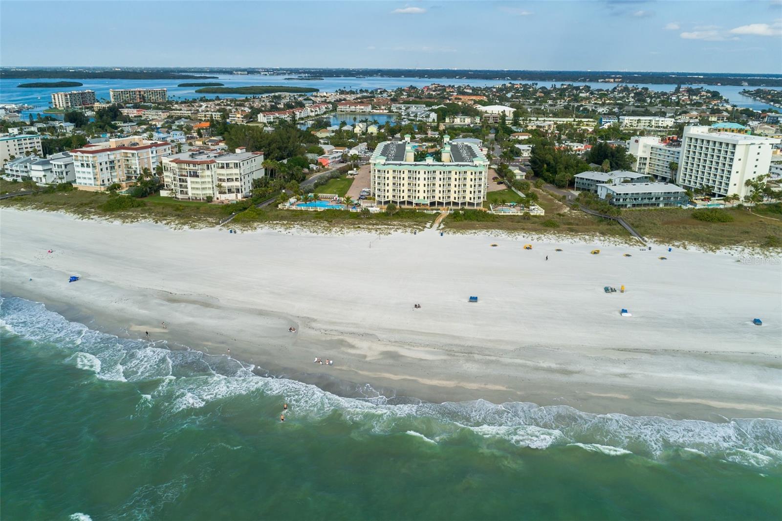 An exceptionally rare opportunity at Sunset Vistas Beachfront Resort. One of only five three-bedroom, three-bath residences in the entire community, this beautifully renovated 1,740-square-foot direct Gulf-front condominium offers an extraordinary combination of space, beachfront living and short-term rental potential. Positioned on the second floor, this exceptional residence features two private direct Gulf-front balconies where sweeping water views and spectacular Treasure Island sunsets become part of everyday life. Beautifully updated approximately two years ago, the residence features luxury vinyl (LVP) flooring throughout and a renovated kitchen showcasing quartz countertops, stylish backsplash, stainless steel appliances and breakfast bar seating. The spacious living and dining areas accommodate family and guests comfortably and open directly to the main Gulf-front balcony. An in-unit washer and dryer add everyday convenience, while the living room includes a queen sleeper sofa, allowing the condominium to accommodate up to eight guests. The Gulf-front primary suite is a true retreat, offering a king bed, private beachfront balcony, large walk-in closet and en-suite bath with quartz finishes, dual sinks, private water closet and jetted soaking tub. The second bedroom functions as an additional king en-suite suite with its own private bath and walk-in closet, while the third bedroom features a queen bed. Three full baths add an exceptional level of convenience rarely found within the resort. Fully furnished, turnkey and rental-ready, this condo-hotel residence offers tremendous flexibility for owners seeking a personal beachfront getaway, investment property or 1031 exchange opportunity. Owners may take advantage of professional onsite management, use an outside management company or self-manage. The residence has an established rental history, with detailed rental information available upon request. Two parking spaces also convey. The oversized 205/206W configuration contributes to its exceptional 1,740-square-foot layout, generous living spaces and rare three-bedroom, three-bath design. With only five such residences within Sunset Vistas, opportunities to acquire this floor plan are exceptionally limited. Sunset Vistas offers a large beachfront heated pool and spa, separate children's pool with fountains and sundeck, beachfront tiki bar, onsite café, fitness center, shared grilling areas and direct access to the sugar-sand beaches of Treasure Island. The second-floor setting offers the best of both worlds: outstanding Gulf views and nightly sunsets with remarkably easy access to the beach, pools and resort amenities. Located just minutes from John's Pass Village and Boardwalk, owners and guests enjoy easy access to waterfront dining, shopping, boating, fishing, dolphin cruises, parasailing and other Gulf Coast activities. This is a rare chance to acquire one of Sunset Vistas' largest and most desirable residences, combining direct beachfront living, extensive renovations, turnkey convenience, resort amenities, management flexibility and proven short-term rental appeal. Schedule your private showing today and experience firsthand why opportunities to own one of Sunset Vistas' rare three-bedroom Gulf-front residences are so seldom available.