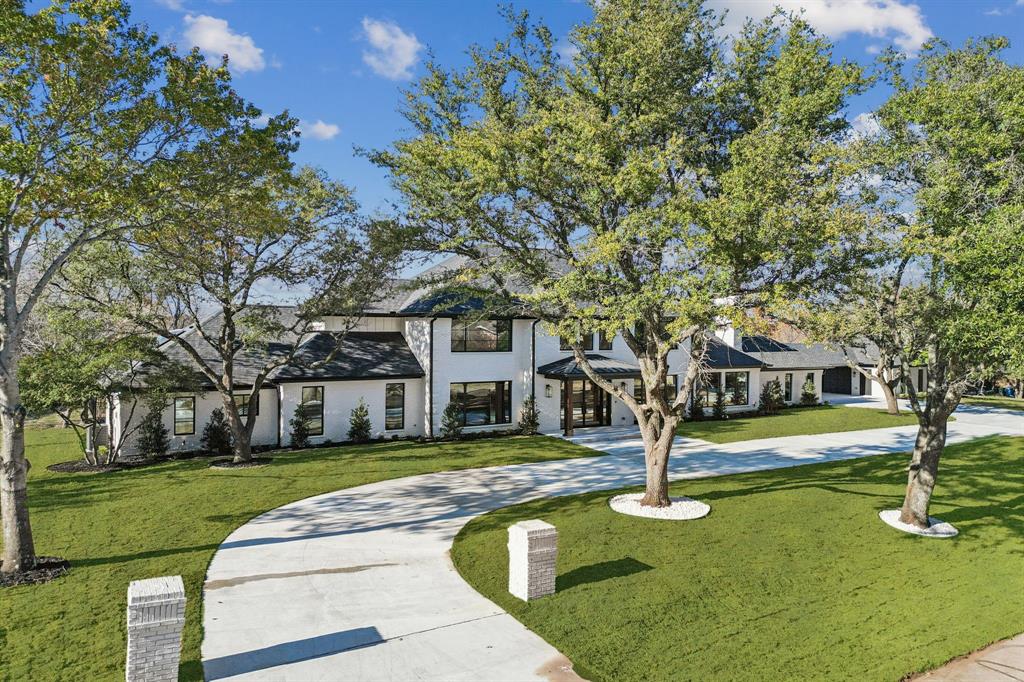 Set on nearly 2.5 acres and transformed through a complete high-end redesign, this 8,039 sq ft estate delivers a rare blend of modern luxury, architectural sophistication, and exceptional quality upgrades within Lovejoy ISD.This expansive 5-bedroom residence offers 6 full bathrooms and 2 half bathrooms. A grand iron front door welcomes you into vaulted ceilings anchored by two beautifully appointed living rooms, each featuring its own fireplace. The main level also includes a dedicated office, a formal dining room, and a luxurious primary suite designed as a private retreat. Here, you’ll find a fireplace, an infrared sauna, standalone soaking tub, towel warmers, dual vanities, and an oversized custom closet with an island and its own laundry room.The kitchen is a standout space featuring white oak cabinetry, quartz countertops, under-cabinet lighting, and a butler's pantry with generous prep areas, creating an ideal setting for both everyday meals and gatherings. A fully finished basement offers additional living space with a bar area and full bathroom.Upstairs, a large open family room provides a versatile gathering space, accompanied by three ensuite bedrooms with walk-in closets, a half bathroom, and a dedicated media room.Outdoor living is elevated by a gated pool and a charming cedar pergola, set within vast, beautifully landscaped grounds. The property also includes a spacious 4-car garage with an epoxy floor, offering both convenience and impressive curb appeal.Conveniently located off Stacy Road near Highway 75, and just minutes from The Villages of Allen, this estate enjoys easy access to a wide array of shopping, dining, and entertainment.