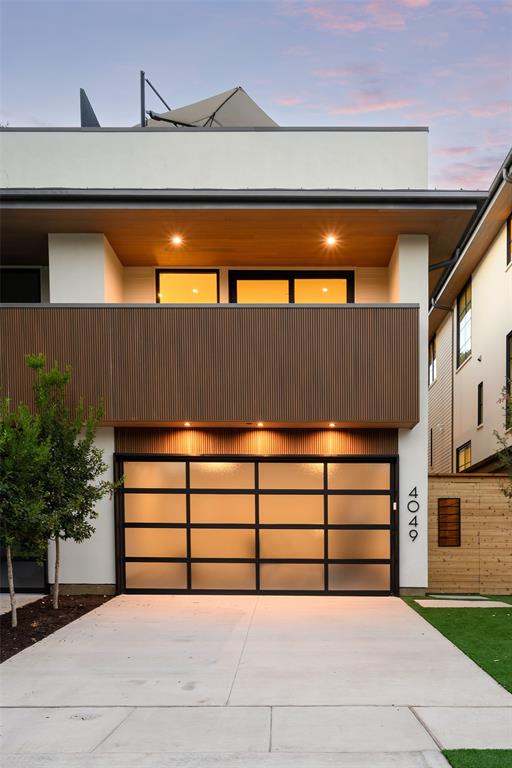 Exceptional new construction by Hudson Construction, 4049 Hawthorne Avenue is located one block from Highland Park and delivers a striking combination of contemporary architecture, sophisticated interiors, and exceptional indoor-outdoor living. Spanning three thoughtfully designed levels, the residence features warm wide-plank hardwoods, natural wood accents, dramatic stone, custom millwork, black-framed windows and doors, and a private elevator providing convenient access to all three floors. At the heart of the home, a showstopping chef's kitchen is anchored by an oversized waterfall stone island and features custom cabinetry, professional-style appliances, abundant storage, and beautiful architectural detailing. The open layout flows effortlessly into the dining and living spaces, where walls of glass fill the home with natural light and a fireplace with floating shelving creates a sophisticated focal point. A dramatic custom bar wrapped in rich blue tile adds another standout element, making the main level ideal for both intimate evenings and larger-scale entertaining. The primary suite is a true retreat, complete with a luxurious spa-inspired bath featuring extensive stonework, an oversized glass-enclosed shower, freestanding soaking tub, dual vanities, and beautifully considered finishes. Secondary bedrooms offer equally polished accommodations for family and guests. The third level sets this residence apart, offering an additional living and entertaining space with a wet bar and direct access to an expansive private terrace. Designed as an extension of the interiors, the impressive outdoor space provides room for multiple seating and dining areas, creating an exceptional setting for entertaining or relaxing outdoors.
