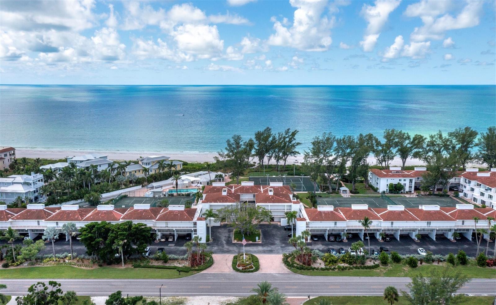 Welcome to effortless Gulf-front living at Club Longboat Beach & Tennis Resort, one of Longboat Key’s established and sought-after beachfront communities. This beautifully updated three-bedroom, two-bath residence is offered turnkey furnished, making it an exceptional opportunity for a full-time residence, coastal retreat or potential income-producing investment. In desirable Building 1, this spacious first-floor residence offers approximately 1,484 square feet of comfortable, thoughtfully designed living space with the rare convenience of no elevators or long walks. The open, split-bedroom floor plan features wide-plank flooring, a light and inviting coastal palette, and an easy flow for everyday living and entertaining. The updated kitchen is the heart of the home, featuring crisp white cabinetry, stainless steel appliances, under-cabinet lighting, a glass tile backsplash and a large center island with seating. Floor-to-ceiling sliders in the great room open to a private, lushly landscaped patio, extending the living space outdoors and creating a peaceful place to enjoy the Longboat Key lifestyle. The spacious primary suite offers direct patio access, a beautifully updated bath with walk-in glass shower and generous closet space. Two additional bedrooms provide flexibility for family and guests, including a den/third bedroom with Murphy bed. A second full bath, full-size washer and dryer, additional laundry cabinetry and abundant storage complete the interior. Just outside your front door is a private storage room and covered parking space, with ample additional guest and resident parking throughout the community. Club Longboat offers approximately 750 feet of direct Gulf-front beach and an exceptional resort-style lifestyle. Amenities include eight Har-Tru tennis courts, several lighted for evening play, an on-site tennis professional, pickleball, two heated swimming pools including separate adult and family pool areas, spa/whirlpool, sauna, beach chairs and umbrellas, grilling areas, bocce, fishing, on-site management and an active social calendar. A new clubhouse with fitness and social spaces is also planned as part of the community’s hurricane restoration, with exciting improvements ahead. Owners enjoy a welcoming community with regular social events, including Friday happy hours and seasonal celebrations. Club Longboat is also pet-friendly for owners and offers exceptional rental flexibility, with a 30-day minimum and up to 12 leases per year. For buyers looking to offset ownership costs, this residence offers a particularly compelling advantage, such as a proven rental history with substantial demand and future bookings potential. The combination of a three-bedroom floor plan, turnkey furnishings, direct Gulf access and flexible leasing has made this an exceptionally desirable rental. Ideally on the Gulf side of Longboat Key, you are minutes from outstanding dining, boating, golf and recreation, with the shops and restaurants of St. Armands Circle and the arts and culture of downtown Sarasota just a short drive away. Whether you are searching for a turnkey beach home, seasonal escape or investment property, this beautifully furnished Club Longboat residence offers the combination buyers want most, direct gulf access, resort-style amenities, three bedrooms, rental flexibility and unmistakable lifestyle of Longboat Key. Simply arrive, unpack and head to the beach.