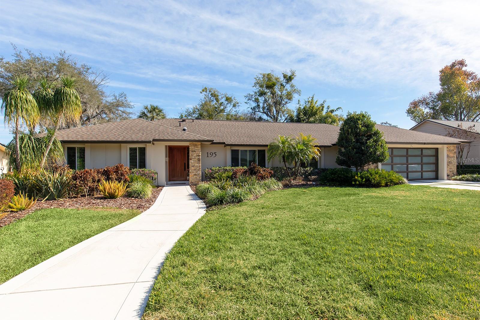 Your search is over! Nestled on a sprawling 3/4 acre lot, this impeccably maintained and updated 4-bedroom, 3-bathroom sanctuary offers the ultimate blend of privacy and elegant design. Located in the highly sought-after gated community of Spring Lake Hills, this home is a rare find that feels like a private retreat while being minutes from everything. The heart of the home is the remodeled gourmet kitchen, featuring sleek granite countertops and a breakfast bar that flows seamlessly into the spacious family room with fireplace. Enjoy your morning coffee in the breakfast nook overlooking the pristine pool and garden area. For formal gatherings, the living areas impress with beamed cathedral ceilings and an abundance of natural light. Unique to this floorplan are two spacious primary suites, both offering private ensuite baths—perfect for multi-generational living or an ultra-luxurious guest wing. The thoughtful split-plan layout includes two additional generously sized bedrooms—one perfectly suited for a quiet home office—both conveniently located just steps from the third full bathroom.  The outdoor living space is a showstopper, featuring a travertine tile pool deck, a covered porch with an elegant tongue-and-groove ceiling, and a dedicated grilling area. Enjoy an extended swimming season with your SOLAR HEATED POOL! All of this overlooks a lush, wooded backyard that provides unmatched tranquility. Windows and doors replaced in 2021. Life in Spring Lake Hills offers a rare blend of security, recreation, and natural beauty. As one of Seminole County’s premier gated communities, residents enjoy the peace of mind provided by a 24-hour staffed gatehouse and the charm of tree-lined private sidewalks. For those who love the water, the neighborhood provides exclusive access to Spring Lake and Lake Destiny via private boat ramps, a community dock, and a fishing pier—perfect for weekend afternoons on the lake. The community’s recreation hub also includes tennis and pickleball courts, a basketball court, and a beautifully maintained park with playground...all just a short walk away.  Despite the secluded feel, you are perfectly positioned for convenience: located just minutes from I-4 for a seamless commute to Downtown Orlando or Maitland.  With its rare double-primary layout, high-end renovations, and nearly an acre of wooded bliss, this home offers a lifestyle of privacy and convenience that truly stands in a class of its own. Welcome Home!