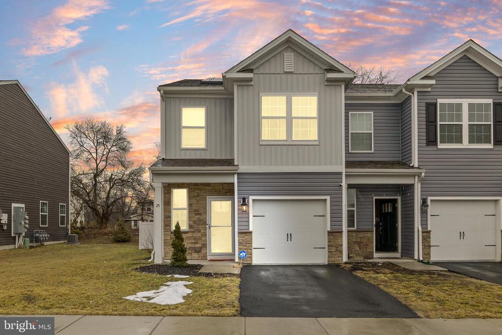 Welcome to 25 Katherine Drive, Burlington Township, NJ, a beautifully maintained luxury townhome offering the feel of new construction without the wait. Built in 2021, this 3-bedroom, 2.5-bath residence with an attached garage showcases modern design, elegant finishes, and true turnkey convenience. High ceilings enhance the open, airy atmosphere, while gleaming flooring flows throughout the entire main level, creating a sophisticated and inviting foundation for daily living. The heart of the home is the stunning kitchen, featuring quartz countertops, crisp white shaker cabinetry, abundant storage, and generous workspace — perfectly suited for both everyday function and entertaining. The open-concept design allows the kitchen to transition seamlessly into the dining and living areas, filling the home with natural light. The backyard is completely fenced in — a rare and highly desirable feature within the community — offering privacy and exceptional outdoor living space. The backyard provides an ideal setting for relaxation, dining, or gathering with guests. Upstairs, the primary suite serves as a serene retreat with a walk-in closet and private en-suite bathroom. Two additional spacious bedrooms provide flexibility for family, guests, or a home office, along with the convenience of a second-floor laundry area. Additional highlights include solar panels for energy efficiency and long-term savings, a one-car garage with interior access, and a private driveway. Conveniently located near shopping, dining, major highways, and commuter transportation, this home offers modern luxury living in a highly accessible location. Experience refined, move-in-ready living at 25 Katherine Drive.