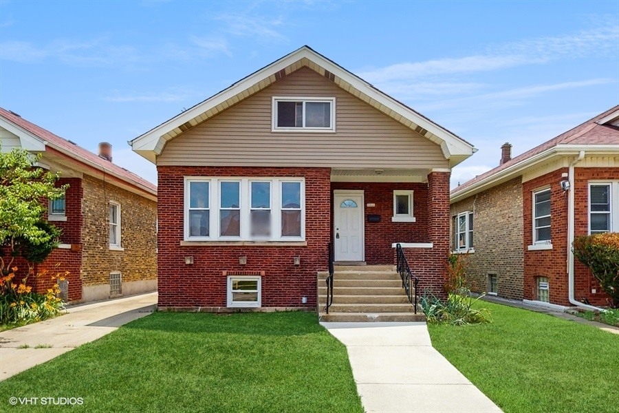 Charming brick bungalow home in the desirable Belmont-Cragin neighborhood-move-in ready! The spacious attic offers potential for additional bedrooms or living space. Enjoy beautiful hardwood floors throughout the main level. Ample parking includes a driveway extending from the street to the rear, a large two-car garage, and an extra gated parking space off the alley. Conveniently located near shopping, parks, schools, public transportation and highway.  Bring your buyers, this won't last long!