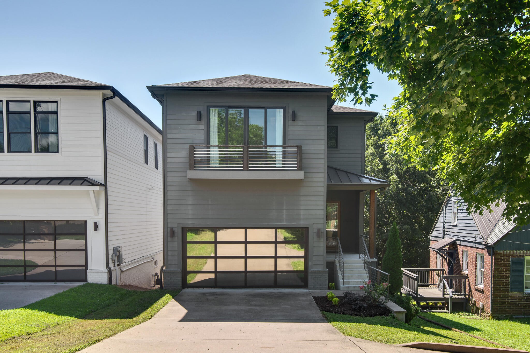 Welcome to 807A Porter Rd, an exceptionally crafted, fully custom home offering over 3,200 sq ft of luxurious living in one of East Nashville’s most walkable and sought-after locations. This is not your typical HPR — it’s a true designer build set just steps from Five Points, Rosepepper Cantina, Jeni’s Ice Cream, Cafe Roze, the Shelby Bottoms Greenway, and more. Designed with care, scale, and intention, this home stands out for its width, natural light, and elevated finishes that surpass even the highest-end infill homes.

Inside, you’ll find a seamless blend of style and substance: wood flooring throughout, a stunning marble backsplash and lime-wash concrete fireplace, remote control blinds, and smart Nest thermostats for every level. The chef’s kitchen includes Bosch gas appliances, quartz countertops, all-wood soft-close cabinets, and a modern glass barn door pantry. Upgraded lighting, mirrors, fans, knobs, faucets, and finishes were selected with no detail overlooked. Functionality is unmatched with three HVAC systems (one per floor), Aquasana whole-house water filtration, on-demand water heater, smart garage, and full Google + AT&T Fiber wiring
.

Upstairs, the home features a generously sized 4th bedroom that doubles as a versatile flex space—ideal for a media room, home office, art studio, guest suite, or playroom. Its oversized layout and deep walk-in closet provide both comfort and utility, making it one of the most dynamic rooms in the home.

The standout feature: a completely separate, full in-law suite on the lower level with its own private entrance and screened-in walkout porch. This space includes a full kitchen with quartz counters and LG appliances, a large living area, bedroom with walk-in closet, full bath, laundry hookups, and private access — ideal for guests, multi-generational living, or generating income with rental potential of $1,750+/month
.

Step outside to enjoy a large, fenced backyard, freshly landscaped walkways, and gravel side yard