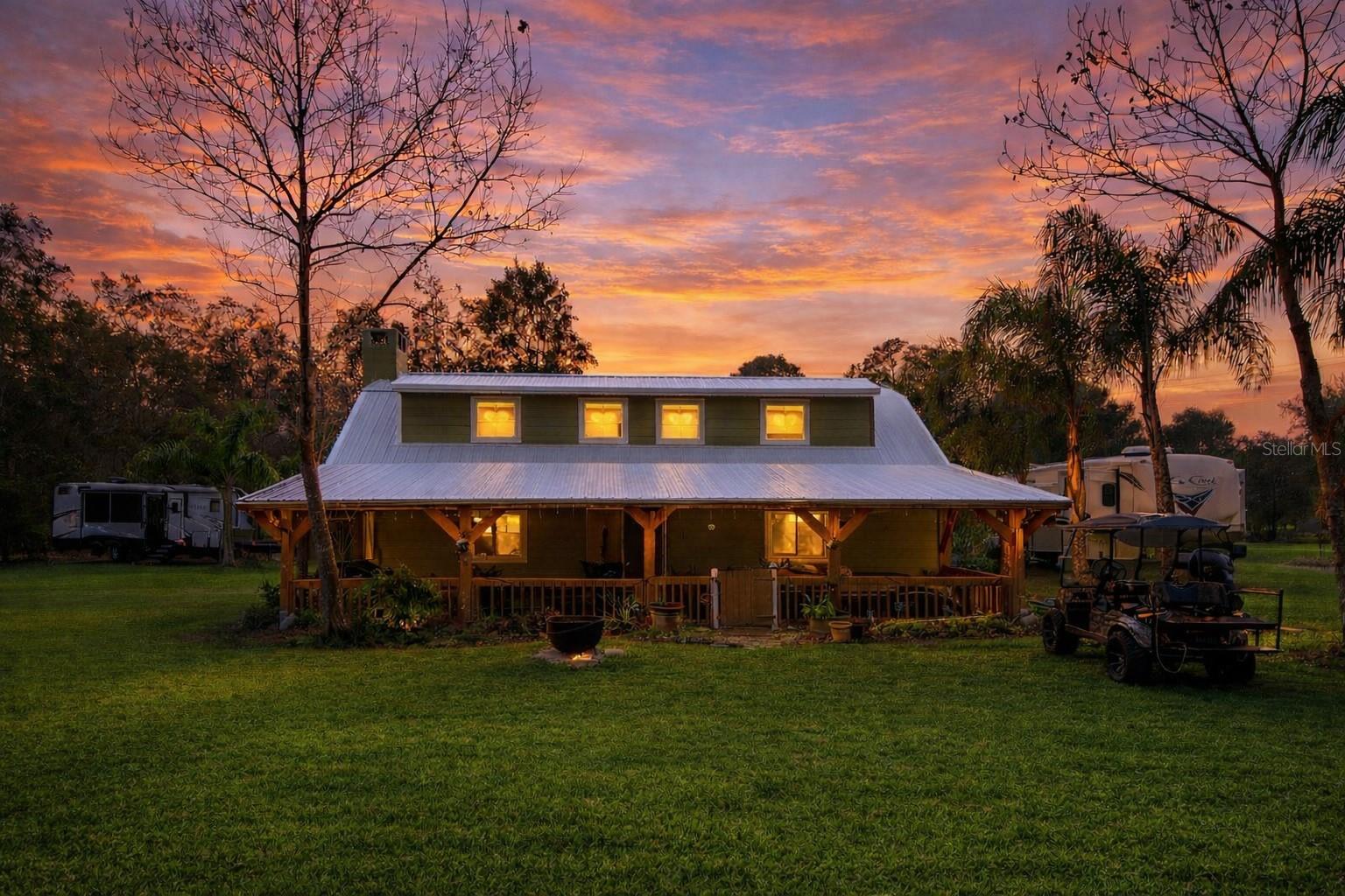 This exceptional 5+ acre property is ideally located just off SR-415, offering excellent accessibility and strong potential for agricultural, residential, or business use. The expansive acreage provides ample space for operations, storage, or future development.The beautiful ranch-style home features a downstairs primary suite with a spacious walk-in closet, two stone fireplaces, elegant laminate flooring, and a bright open-concept living and kitchen area, perfect for entertaining. The second floor overlooks the dining area, adding architectural character and openness. Enjoy both a front porch and a back porch with peaceful pond views, plus a dedicated downstairs office and an oversized laundry room as an added bonus.The property includes two separate barns:A large 2,292 sq ft barn with insulated flooring, a concrete slab, and a walk-in coolerA second 950 sq ft barn, ideal for storage or workspaceBoth barns are well-suited for heavy equipment, large items, or home-based business operations. An RV pad with its own septic system adds further versatility.This is an incredible opportunity to own a versatile property with the potential to be transformed into a highly desirable barn-style event venue, one of today’s fastest-growing trends. Its strategic location makes it attractive to guests from Orlando, Jacksonville, Daytona, and New Smyrna, positioning it for strong demand and income potential.