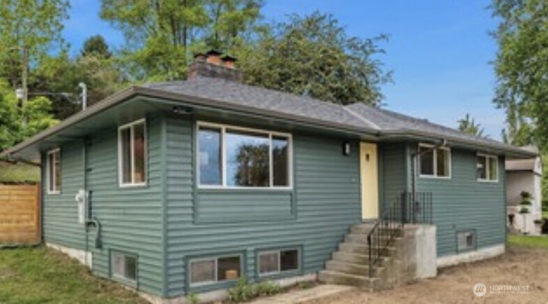 Perched on a spacious corner lot with sweeping views of Lake Washington, this beautifully remodeled mid-century home blends timeless style with modern updates. The main level features three bedrooms, gleaming hardwood floors, an updated kitchen and light-filled living spaces thoughtfully designed to capture the stunning lake views. Cozy wood-burning fireplaces on both levels add warmth and character throughout. The lower level offers exceptional flexibility with a spacious recreation room, new carpet, a newly added 3/4 bath, a fourth bedroom, abundant storage, and a separate exterior entrance—ideal for guests, multigenerational living, a home office or potential rental income. Outside, enjoy a private backyard with a patio perfect for relaxing or entertaining, plus driveway parking for up to four vehicles and offers potential for a DADU. Extensive improvements, including a new roof, gutters, electrical, interior paint, carpet and lighting, provide peace of mind for years to come. Conveniently located near light rail, parks, Lake Washington beaches, marinas, neighborhood restaurants and cafés, with an easy commute to downtown Seattle and Sea-Tac International Airport.