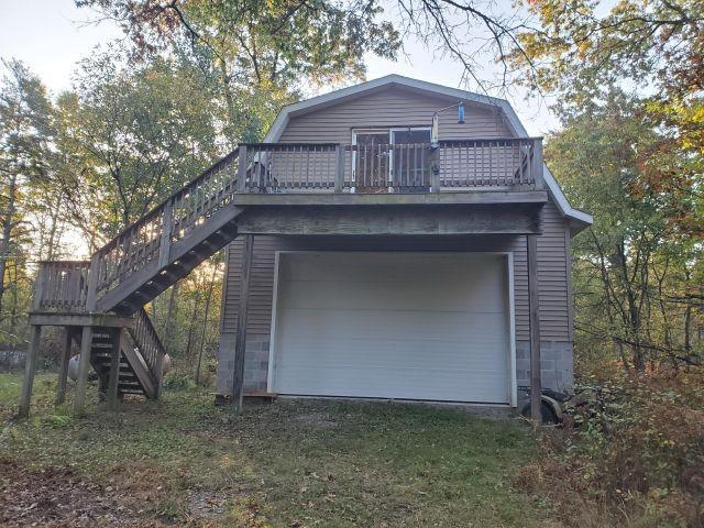 BEAUTIFUL 10 ACRE PARCEL!! Heavily wooded property with trails for ATV and snowmobiling and would make the perfect hunting camp with a variety of wildlife in the area. There is a very nice 2-story, 26x36 garage/building on the property for storing your Up North toys which could be finished to your liking that has solar panels, propane heater, 10x16 pull-thru doors on lower level and two spacious upper deck areas where you can relax and enjoy the views. There is also a generator-operated well on the property for your water needs. This garage and property has a lot of potential and use and the property is wooded with mature hardwoods. Hurry, this 9.98 acre parcel will not last long!