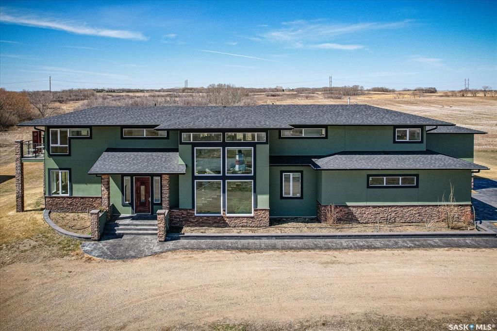 Modern acreage living just minutes from Saskatoon! Located on the edge of the city, this 68.9-acre property offers space, privacy, and future potential. Built in 2017, the 3,000 sq. ft. home features 3 bedrooms and 3 bathrooms. The main floor includes a gas fireplace, spacious kitchen with stainless steel appliances, and dining area opening to a stamped concrete patio with natural gas BBQ hookup and radiant heat. The second level offers a family room with wet bar and deck access, plus a primary suite with walk-in closet, ensuite, and private balcony. Additional features include two furnaces, two central A/C units, and heated crawl space. Heated double attached garage and heated RV/motorhome bay. Yard includes trees, garden area, and underground sprinklers. City water line, well, and holding tank. Located ½ mile off Hwy 219, under 10 minutes to Saskatoon amenities.Interior photos from a previous listing; property is tenant occupied.