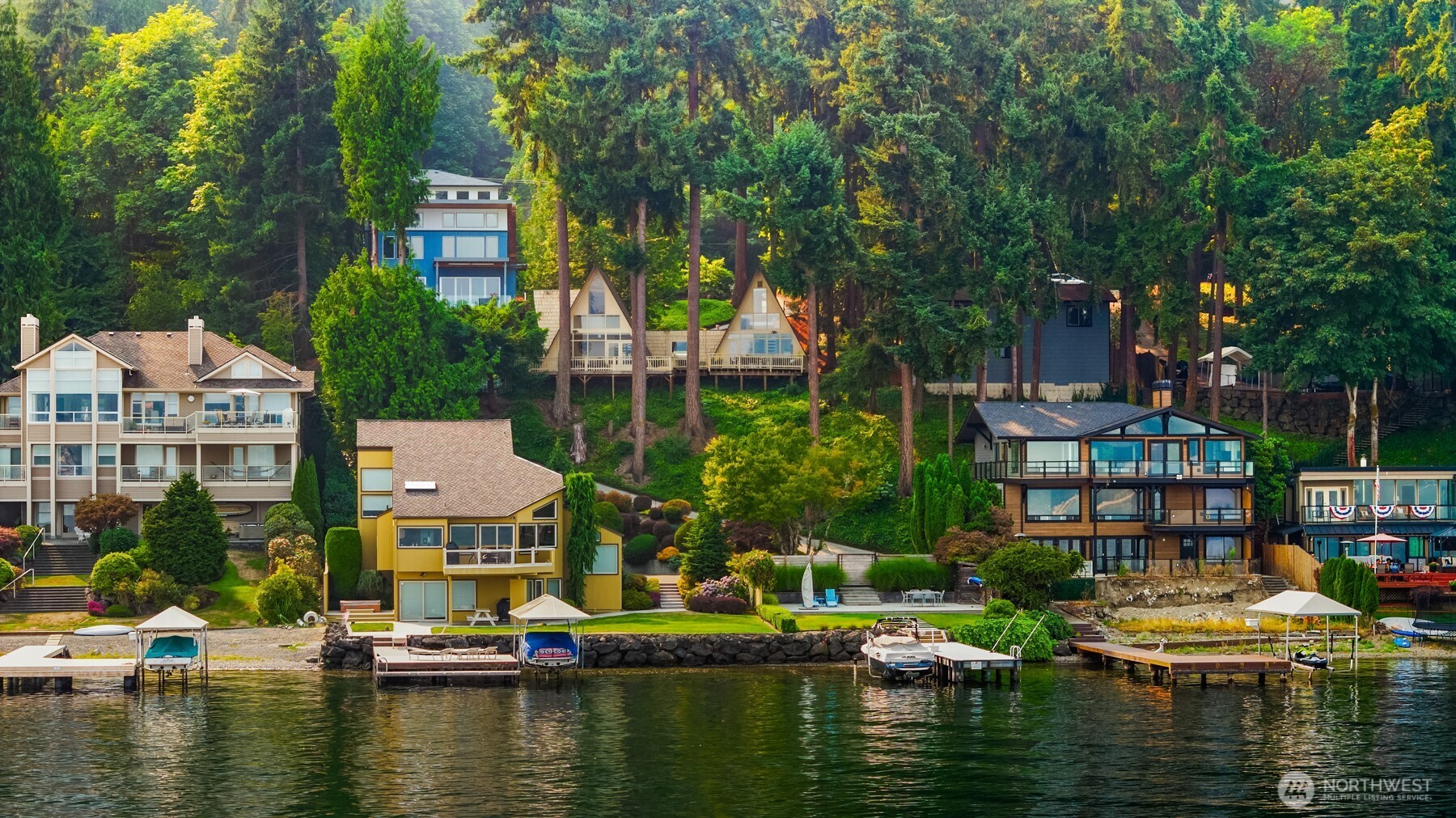 Scenically perched above the shores of Weowna Beach on Lake Sammamish with 40' of shared waterfront & sprawling panoramic views, this iconic double A-frame cabin is the most affordable beachfront property in town! Tucked quietly below the parkway, the majestic 9,147sf lot is a prime development opportunity boasting an exceptional lakeside vantage point with a unique sense of seclusion. Masterfully renovated in 2016, the spacious level beachfront features paver patio, irrigated lawn, additional parking & modern steel dock with boat lift potential. Originally built in '62 as a welcome center for the Seattle World's Fair, this bohemian retreat has a rich pedigree with many stories to tell and plenty of life still left to offer. Currently ran as highly successful vacation rental, the 2,260sf floor plan features 3 beds, 3 baths, soaring wall-to-wall view windows, an open kitchen with granite counters & breathtaking full-length entertainment deck. Imagine the possibilities...