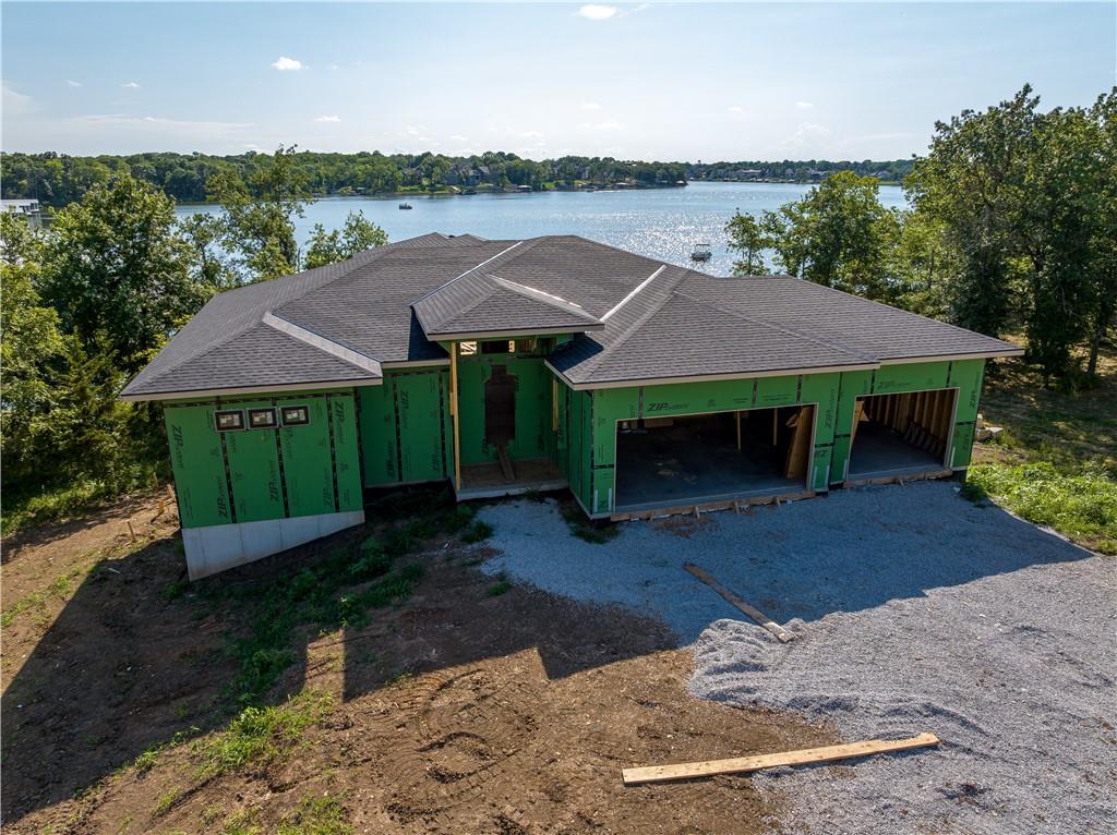 Stunning Lakefront Reverse 1.5-Story by Walker Custom Homes in Lake Winnebago! This exceptional lakefront estate offers a gentle slope to the water’s edge and panoramic main channel views. The thoughtfully designed floor plan features two bedrooms on the main level and two additional bedrooms in the walkout lower level—each with breathtaking lake views and a private full bath.

The main level showcases an open-concept layout perfect for entertaining, complete with a spacious living area, gourmet kitchen, dining space, and a large prep kitchen with stainless steel appliances. The primary suite includes a luxurious bath, deck access, and a walk-in closet connected directly to the laundry room for added convenience.

Downstairs, 12-foot ceilings create a bright, open atmosphere, featuring a media room, full wet bar, and an expansive bonus room located under the suspended garage—ideal for a home gym, game room, or storage. There's even a dedicated lake-day bathroom and an additional garage door at the back of the home for all your lake toys.

Enjoy outdoor living on the covered deck, outfitted with a fireplace, TV hookup, composite decking, and a finished ceiling for a dry patio below. Built with quality and efficiency in mind, this home includes zoned high-efficiency HVAC, engineered I-joists, and is pre-wired for a home sound system.

Nestled on a private lot with the lake in the back and green space in front—this is luxury lake living at its finest!