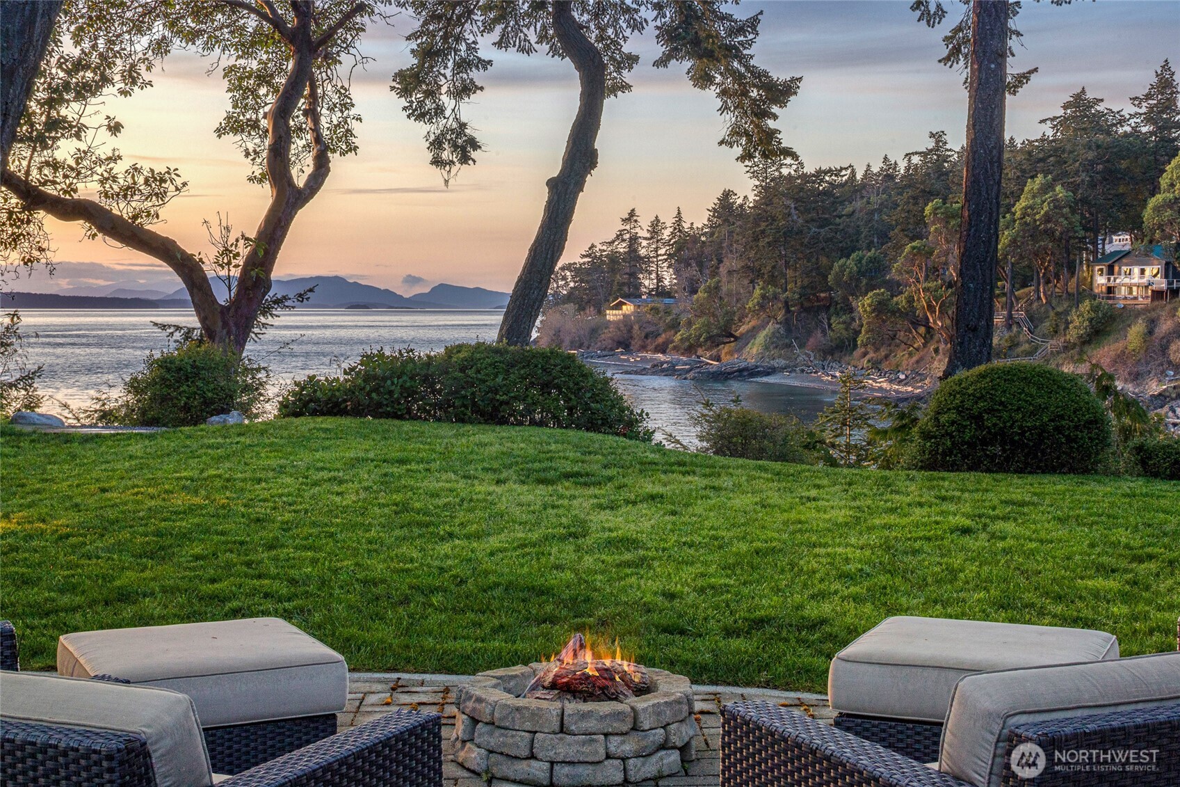 Architecturally stunning, NW-facing contemporary waterfront residence sited on coveted Sunset Point. Showcasing exceptional craftsmanship, two mirroring glass walls--designed by Vandervort Architects--capture abundant natural light and breathtaking Strait views. Unwind & recharge in the private primary suite; upstairs, a glass bridge connects office & flex space with a guest suite, mini-loft, exercise area & sundeck. An epicurean delight, the kitchen emphasizes luxury, function and style.  Outdoor amenities include: lovely patio equipped with full kitchen, beautifully landscaped varietals, lighted steps with kayak racks leading to a sandy beach with registered mooring buoy. A meticulously designed coastal retreat, refined as it is inviting.