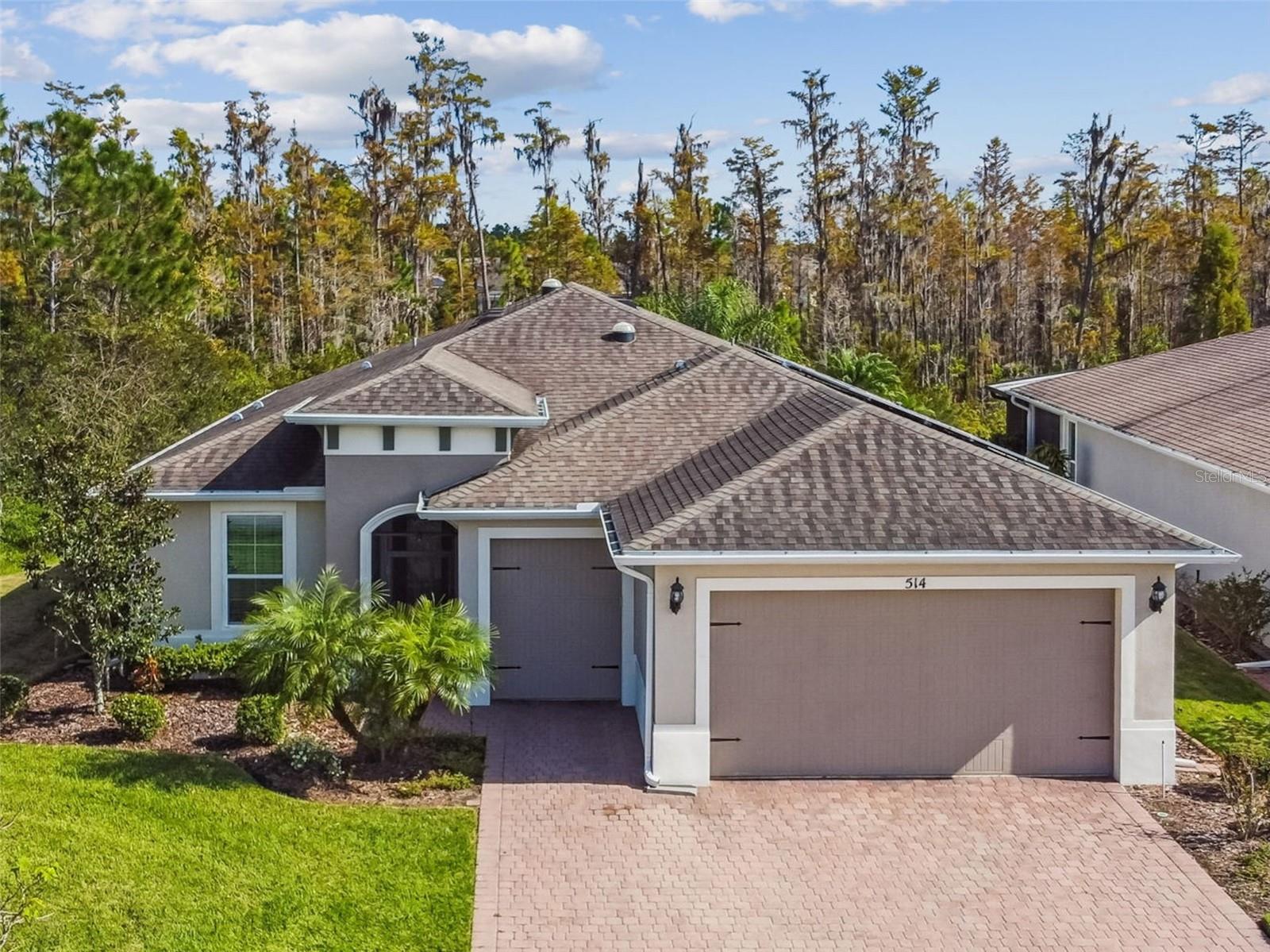 Exceptional Custom Home with Dual Primary Suites & Tranquil Conservation ViewsExperience luxury and thoughtful design in this stunning custom Calto model, featuring two primary bedroom suites, a large study, and an enclosed Florida Room that seamlessly blends indoor comfort with outdoor serenity. Nestled on a large corner lot with peaceful conservation views, this home offers the perfect retreat for those who appreciate elegance and privacy. The open-concept layout welcomes you with leaded glass entry doors. The solar tubes and huge windows in the Great Room bathe the interior in natural light. The elegant 20" x 20" slate-look porcelain tile flows beautifully throughout, complemented by easy-care laminate in the Florida Room.The chef’s gourmet kitchen is a true showpiece, featuring a massive island, double ovens, cooktop, quartz countertops, a large walk-in pantry, and custom cabinetry with thoughtful storage solutions including pull-out drawers and a built-in waste bin.Both primary suites boast private en-suites, while guests enjoy a separate full bath with vanity. Additional highlights include volume ceilings, framed mirrors, upgraded lighting and plumbing fixtures, central vacuum system, soft water system, laundry room with utility sink, and wired surround sound in both the Great Room and Florida Room.Outdoor living is just as inviting with a screened front entry, expansive screened lanai, and a newly enclosed year-round Florida Room (Superior Aluminum Company, 2025) with panoramic conservation views. The 2-car plus golf cart garage offers ample storage for both vehicles and leisure equipment.Recent upgrades include:New Lennox high-efficiency A/C with Ecobee Smart Thermostat (2024)Whirlpool double-door refrigerator with bottom freezer (2024)New Hot Water Heater (2025)Double custom privacy doors for third bedroom (2024)Enclosed year-round den/family room (2025)Motion-detected exterior lighting (front, left, right, 2025)Fenced paver patio with gate – perfect for pets (2025)Custom master closet with drawers, shelving & shoe rackNew smoke detectors installedThe solar panels (completely paid) provide EXTREMELY low electricity bills adding huge monthly savings to your budget. Every element of this home reflects pride of ownership and attention to detail. Relax, entertain, and enjoy the beauty of Solivita living surrounded by nature and luxury.