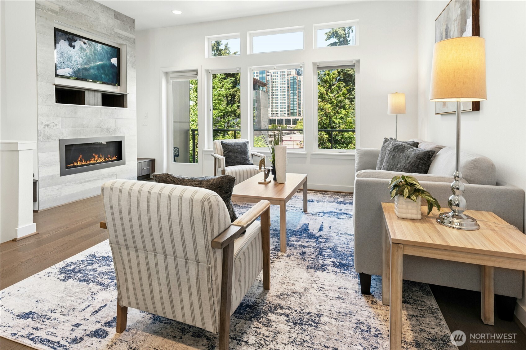 Experience modern city living in the heart of Downtown Bellevue, where elevated views, sophisticated design, and a beautifully maintained, move-in-ready interior come together. This stylish 3 bedroom, 3.25 bath residence features a light-filled open great room with oversized windows and easy access to the adjoining balcony, with city views providing a striking backdrop. The designer kitchen blends style and function with high-end appliances, sleek cabinetry, generous prep space, and an open layout that flows naturally into the dining and living areas.    Upstairs, the spacious primary suite enjoys impressive city views and features a large 5-piece bath with refined finishes and two generous closets. A second bedroom with full en suite bath and conveniently located laundry complete the upper level. Downstairs, a spacious bonus room with high ceilings opens directly to a private patio, offering flexible space for relaxing, working, media, fitness, or guests. A third bedroom and additional bath add even more versatility.    Beautifully cared for throughout, the home offers a modern architectural feel, brand-new carpet, warm finishes, and a polished sense of style. Two-car tandem garage. Exceptional Downtown Bellevue location close to premier shopping, dining, parks, entertainment, major employment centers, top-tier schools, and convenient transit—including the new light rail just blocks away.
