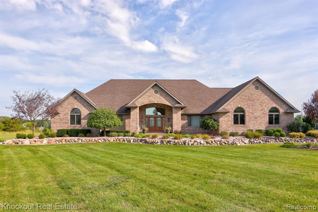 Like a queen’s gambit in a master’s game of chess, this rare listing in Frankenmuth schools makes a bold opening—strategic, elegant, and impossible to ignore. Set on 5 acres, this 2,700 sq. ft. brick ranch (built in 2002 by Bavarian Builders and just 4 miles from N Main Street with Blumfield taxes) greets you with a circular drive, manicured lawn, lush landscaping, a brick paver walkway, and stately double front doors. Step inside to soaring 20’ ceilings in the living room, 9’ ceilings throughout, and walls of windows framing sweeping views of the private backyard and patio. The kitchen pairs Pioneer oak cabinetry with Corian countertops, high-end stainless appliances, and a sunny breakfast nook. A formal dining room doubles as the perfect flex space for an office, den, or playroom. The west wing features three bedrooms with a Jack-and-Jill bath, plus a spacious primary suite with walk-in closet. Off the insulated three-car garage, you’ll find a large laundry/mudroom and an additional bath. The finished basement—newly updated with carpet and LVP flooring—is a true crowd-pleaser. A custom theatre area sets the stage for cozy movie nights or lively game days, while a hickory kitchen makes entertaining effortless. A fourth bedroom, office, and bath with private garage access offer an ideal setup for a mother-in-law suite or multi-generational living. Practical upgrades provide lasting peace of mind: a newer Rheem water heater with on-demand circulation, Trane dual-burner zone furnace for energy efficiency, Anderson windows, and battery backup sump pumps. In the game of house hunting, this home is the ultimate checkmate.