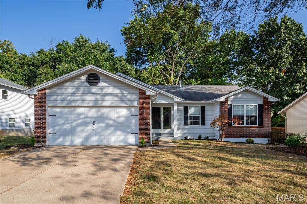 Welcome to 1298 Golden Gate Ln, where modern design, privacy, and comfortable living come together in a beautifully updated home! Located in the highly desirable Golden Triangle Estates and within the Francis Howell School District, this 4-bedroom, 3-full-bath home sits on a spacious 1/3+ acre lot backing to woods, offering a peaceful and private setting. Step through the entry doors and prepare to be impressed. The thoughtfully renovated interior features a designer-inspired finish, open-concept floor plan, luxury vinyl plank flooring, vaulted ceilings, and stylish modern details throughout. The stunning new kitchen showcases beautiful quartz countertops, soft-close cabinets, brand-new stainless-steel appliances, and a textured Spanish tile backsplash. The inviting living area features a striking accent wall with an electric fireplace, creating a warm and sophisticated space for relaxing or entertaining. The spacious primary suite offers a vaulted ceiling and an updated primary bath with dual vanity. Three additional generously sized bedrooms and two additional full bathrooms provide plenty of flexibility for family, guests, a home office, or hobbies. The partially finished basement adds valuable living and recreation space. An attached 2-car garage provides convenient parking and storage. Outside, enjoy the tranquility and privacy of the wooded backyard while remaining conveniently close to shopping, dining, parks, major highways, and all that St. Peters has to offer. Beautifully renovated. Stylishly designed. Privately situated. This move-in-ready home truly makes an impression from the moment you walk through the door. Bring your buyers! Thanks for showing.