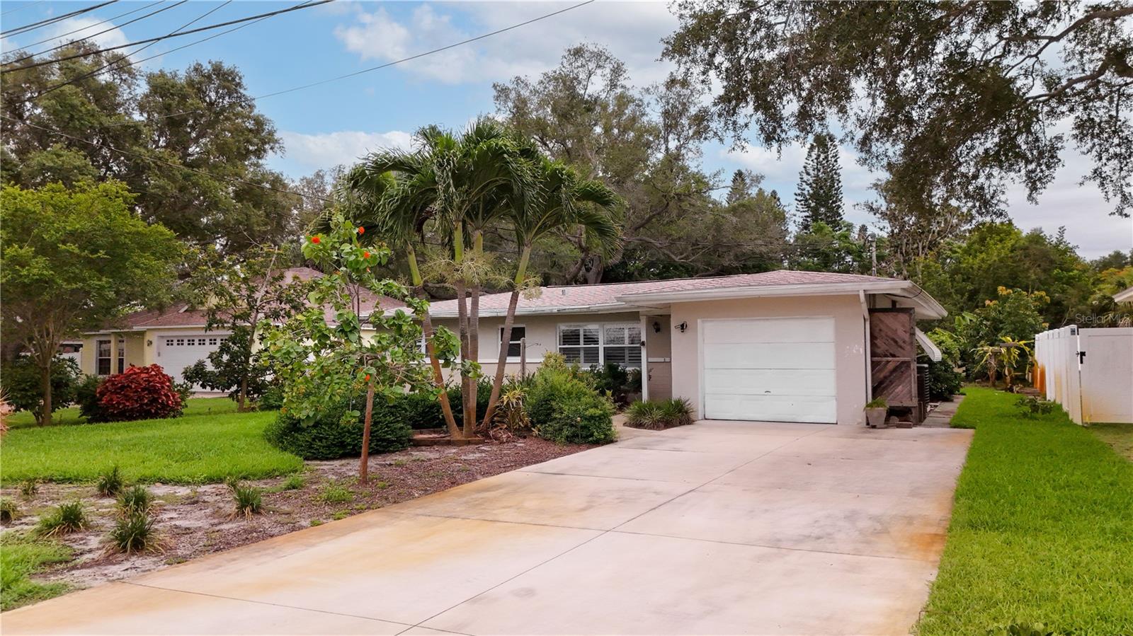 One or more photo(s) has been virtually staged. Embrace the Florida lifestyle in this beautifully maintained 2-bedroom, 1-bath, 1-car garage home situated on an oversized 0.23-acre lot in one of Largo's most desirable areas. The thoughtfully designed layout features a spacious kitchen that opens to a light-filled dining area with ample room to add a bar or beverage station, creating the perfect setting for entertaining. A convenient pass-through window connects the kitchen to the Florida room, making indoor-outdoor gatherings effortless. Step outside to enjoy the beautifully landscaped backyard, complete with a storage shed and plenty of space for gardening, pets, play, or future outdoor enhancements. Located in a non-flood zone and approximately 2 miles from the Gulf waters and the sugar-sand shores of Indian Rocks Beach, this home offers peace of mind and an exceptional coastal lifestyle. Enjoy easy access to nearby favorites including George C. McGough Nature Park, the Pinellas Trail, Walsingham Park, Seminole City Center, and a wide variety of shopping, dining, entertainment, and recreation options. Whether you're searching for a full-time residence, seasonal retreat, or investment opportunity, this property delivers location, value, and Florida living at its finest. Schedule your private showing today and discover everything this exceptional home has to offer!