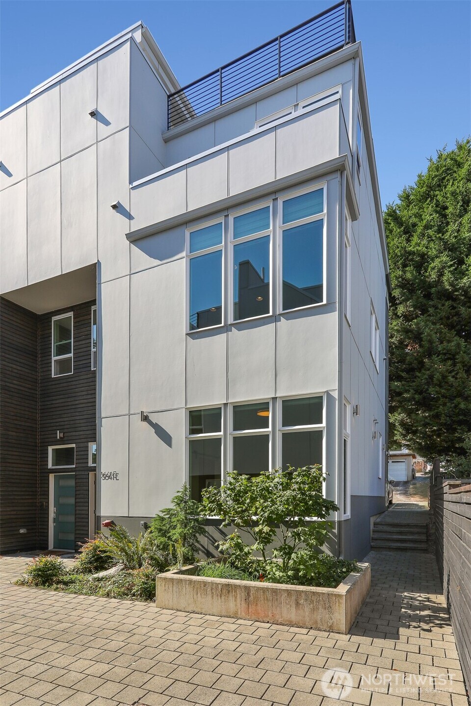 Fall in love w/ this large 3 bdrm, 2 bath Magnolia townhome. A gracious entry courtyard welcomes you & allows natural light to fill the rooms. Built Green in 2020 w/ a unique floor plan, 20-ft floor width & maple hardwood throughout. 1st floor features 2 bdrms & full bath. Spacious 2nd floor w/ open living, dining & gourmet kitchen is perfect for entertaining or quiet relaxation. Private 3rd floor primary suite w/ walk-in closet & marble 4-fixture bath. Enjoy sweeping views from the expansive rooftop deck w/ grill & overhead lighting. Off-street parking conveniently at backdoor. Ductless mini split – A/C. Triple-glazed windows w/ roller shades. Wired for car charger. Great location w/ easy access to downtown, Ballard, bike trails & transit.