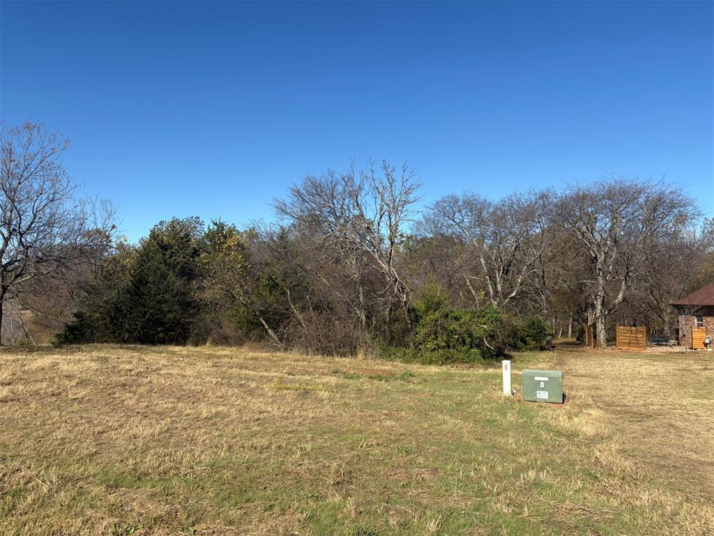 Nestled on a 1.5-acre lot in the desirable Cooper’s Creek Addition, this property offers an exceptional opportunity to build your dream home in a wooded and quiet neighborhood. The natural landscape and gentle slope make it perfect for a walk-out basement, providing both beauty and functionality.Conveniently located close to Riverwind Casino, restaurants, and just 15 minutes from the University campus and shopping district, you’ll enjoy the ideal balance of privacy and accessibility. With public utilities available, this prime location combines comfort, convenience, and the peaceful charm of wooded surroundings.