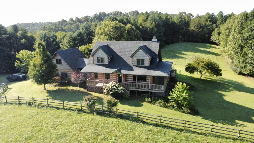Discover the privacy, space, and versatility of this exceptional 46.5-acre property in Woodlawn, Virginia. Priced at $899,900, this well-appointed 3-bedroom, 3-bath home is a Stonemill Custom Log Home. All the logs are hand hewn hemlock. The home offers approximately 3,114 finished square feet, including a finished walk-out basement, plus a two-car garage. Built in 2005, the home features a spacious layout with 1,668 square feet on the main level, 706 square feet upstairs, and 740 finished square feet in the basement. The main level includes the kitchen with a Shaw fireclay sink, dining room, primary bedroom, family room, and laundry, with 2 additional master bedrooms, each with its own bathroom provide comfortable space for family and guests. Each bath has its own laundry hookup. Set on approximately 46.5 acres, the property offers a rare combination of privacy, acreage, mature trees, wooded areas, rolling terrain, and scenic views. The expansive land provides numerous possibilities for recreation, a mini-farm, horses, outdoor activities, or simply enjoying the peace and beauty of the surrounding countryside. Additional features include multiple outdoor structures/amenities. There are 9 12x12 stalls and tac room located in the barn. If you've been searching for a substantial acreage property with a comfortable home and room to spread out, this Woodlawn property is an opportunity worth exploring.