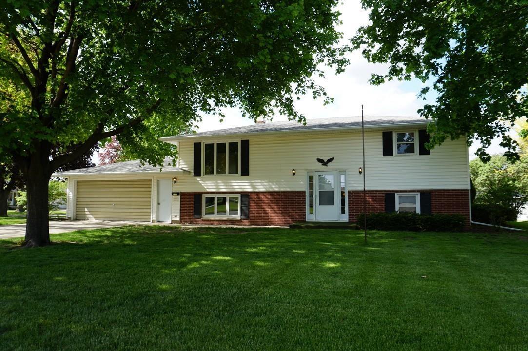 A rare find – a true 4-bedroom, 2-bathroom home with 1,635 finished sq ft situated on a large corner lot! The traditional split foyer floor plan offers multiple living areas over two levels. The main level features an open living room that flows into the kitchen and dining room. The dining room has a sliding door to an elevated deck. Down the hall are two nicely sized bedrooms and a full hall bath. Downstairs is a large family room, two bedrooms and a second full bath. A utility room with laundry has access to the 2-car garage (22 ft x 24 ft), and a back door leads out to the yard. The 75 x 160 lot (0.276 acres) features mature trees and landscaping with areas well-suited to gardening and other hobbies. This well-cared-for home is ready for new owners!