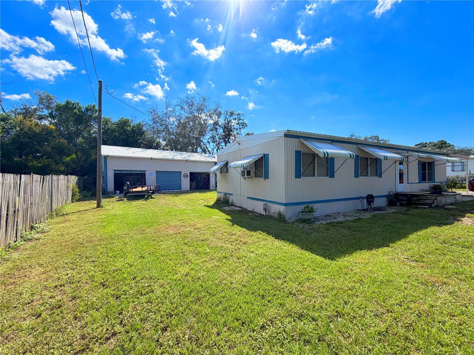 CAR ENTHUSIASTS, MECHANICS, AND HOBBYISTS — THIS IS THE OPPORTUNITY YOU'VE BEEN WAITING FOR! Welcome to 9634 Ed Street in Hudson, Florida, where endless possibilities meet affordability! Situated on approximately half an acre, this 2 bedroom, 2 bathroom home offers a rare combination of comfortable living space, an expansive yard, and an incredible detached four-car mechanic's garage complete with a vehicle lift and dedicated paint shop!Whether you're a professional mechanic, automotive enthusiast, collector, or someone who simply needs room for projects and equipment, this property delivers the space and versatility you've been searching for. The impressive detached workshop offers generous room for vehicle maintenance, restoration projects, equipment storage, and much more. Inside the home, you'll find a functional layout featuring two bedrooms, two bathrooms, a kitchen, and comfortable living and dining spaces ready for your personal touch.Step outside and enjoy the freedom of approximately half an acre, providing plenty of room for outdoor activities, additional parking, gardening, or simply enjoying your own private space. Conveniently located in Hudson, with easy access to shopping, dining, and major roadways, this property offers the perfect balance of accessibility and room to spread out.ALL OF THIS FOR UNDER $200,000! Opportunities to own a property with this much land, a four car garage, vehicle lift, and dedicated paint shop at this price point are hard to come by. Whether you're looking for your next home, a place to pursue your automotive passions, or a property with incredible potential, 9634 Ed Street deserves your attention. Schedule your private showing today and discover everything this unique property has to offer!