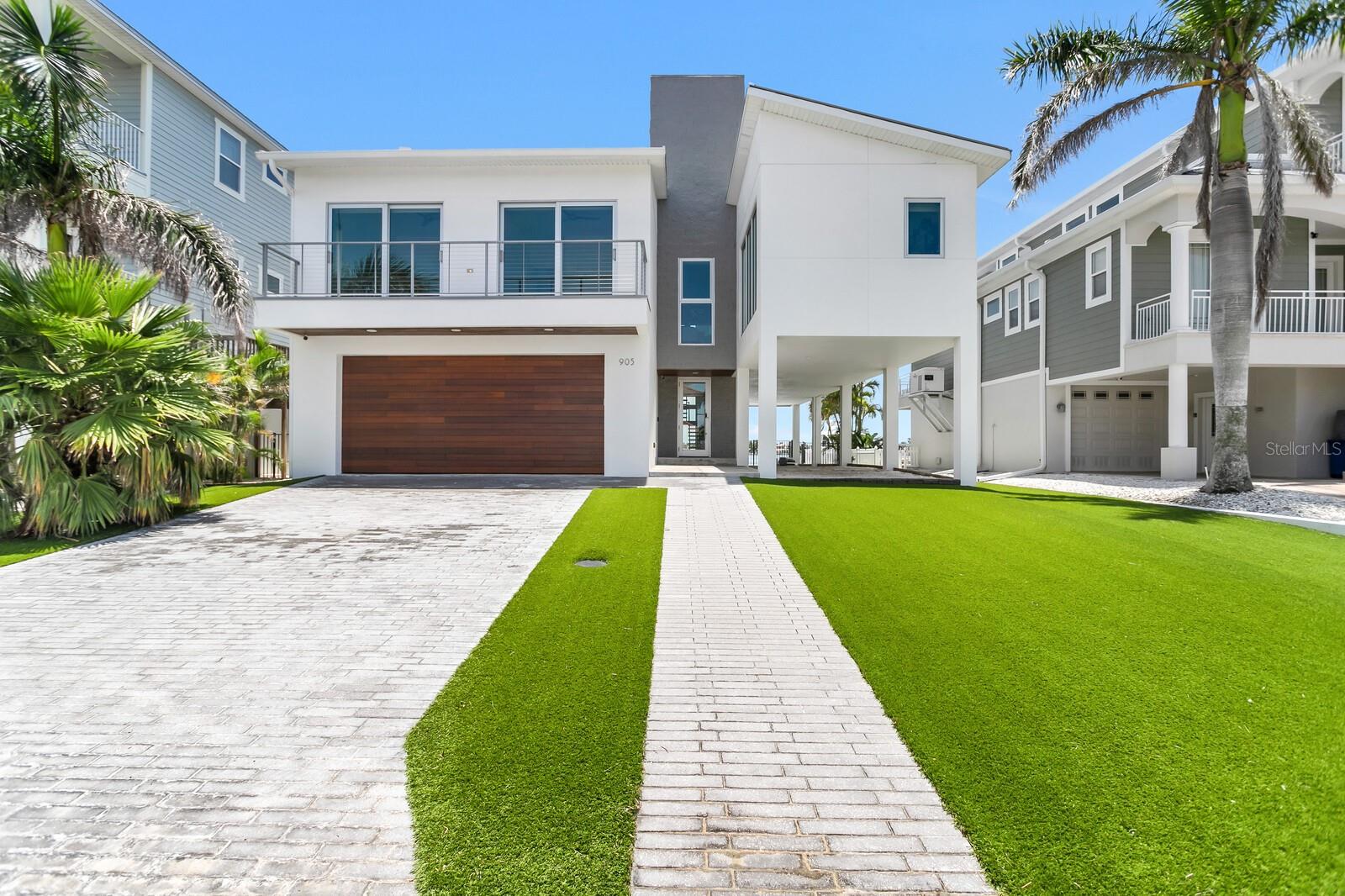 Move-in ready, stunning newer-construction home built on what may be some of the best protected water in the beaches of Pinellas County, bring your 50+ foot yacht!

Featuring a brand new 2025 Glass Artisanal Elevator, which alone cost nearly $200K! All-new artificial turf installed in both the front and back yards in 2024, creating a zero-maintenance xeriscape.

Enjoy an awesome open floor plan overlooking the water. 4 bedrooms (or one awe-inspiring office with floor-to-ceiling glass), 4 bathrooms, and a 4-car garage.

The newer, south-facing pool (if you know, you know) was completed in 2019 no expense spared. Includes a new 2024 smart variable-speed pool pump and pool heater.

Dock (2019), with a 2024 catwalk, and 2024 new Neptune G-6 high-speed 16,000 lb lift, plus a 2024 new high-speed Neptune 3,000 lb lift.

High ceilings in the living room are adorned with exotic South American Cumaru wood, adding warmth and sophistication. The entrance stuns- with commercial-grade glass doors and a modern entryway.

All windows are PGT impact-rated, with most of them outfitted with electric smart blinds.

Kitchen has all Bosch stainless steel appliances and imported Italian marble backsplash with modern white euro cabinets. 

Includes a new 2024 washer in the laundry room.

The rooftop will amaze over 1,500 sq ft with open views on both sides to enjoy fireworks and boat parades. There’s also a spacious covered patio downstairs with elegant white cedar ceilings.

This home is a statement piece- a true work of art.