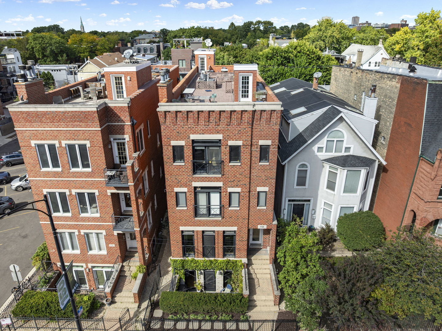 Welcome home to this stunning extra-wide, raised first floor Lincoln Park 3bed-2bath condo with garage parking and deeded rooftop space included in the price! This updated home in Oscar Mayer school district offers a large and very functional layout on a rare oversized lot. Designed for both style and function, the condo features refinished hardwood floors throughout, 10' ceilings, and floor-to-ceiling windows that flood the home with natural light. Retreat to the luxurious primary suite located away from the street, complete with new custom 'Inspired' Closets walk-in (2024), an en-suite spa-like double-vanity bathroom, whirlpool soaking tub, and separate shower. Two additional large bedrooms provide flexibility for family, guests, and/or a home office. The modernized kitchen boasts 42" cabinets, granite countertops, stainless steel appliances, new hardware, and a large breakfast island that seamlessly connects to the dining and living areas. Gather around the custom gas fireplace (2024) for cozy nights in. To top it all off, enjoy your private rooftop area with sweeping city skyline views - perfect for entertaining. New 2025 water heater and updated ceiling fans in 2024. Garage parking is included, along with in-unit laundry and peace of mind from well-funded building reserves. All this, in an unbeatable location-steps from the Fullerton L stop, DePaul campus, Oscar Mayer school, Armitage retail, and some of Lincoln Park's best dining & nightlife spots. Quick access to the lake and I-94 ensures convenience in every direction.