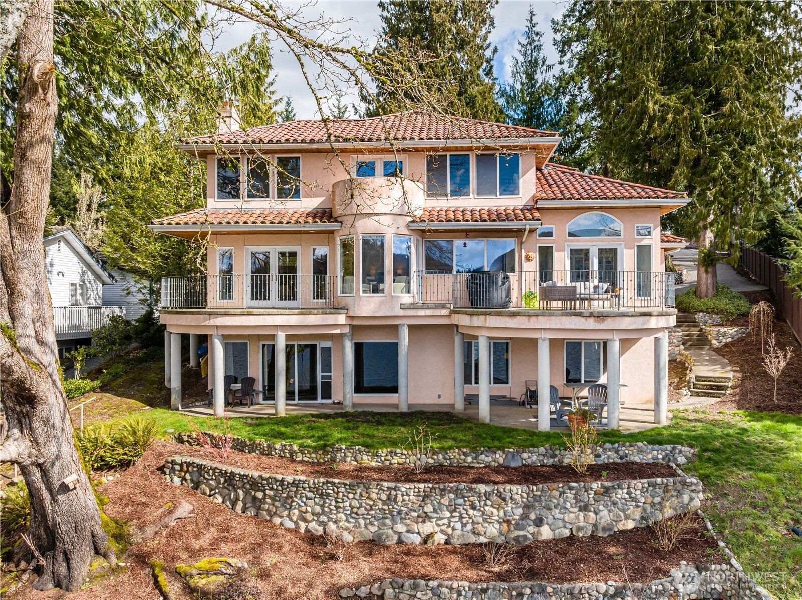 Rare opportunity to own this waterfront on Big Lake.  Private dock with boat lift, 1/2 acre lot, appx 3,800 sqft custom built home on 3 levels.  Primary suite is entire top floor with 180 degree views of the lake.  Actually, views of the lake from just about every window.  Heated floors, granite, tile, stainless appliances, luxury vinyl plank, glass block accents, curved staircase, huge rec-room downstairs.  Tons of storage in partially finished room off basement.  Multiple decks with views of the lake.  2 car garage with electric charging, sink and bathroom, circular driveway, and a sport court.  Overlook Golf Course is literally across the street.  Big Lake is one of the few waterski lakes in Skagit County.  ORV trails are nearby and the lake is just minutes to I-5 or SR 9.