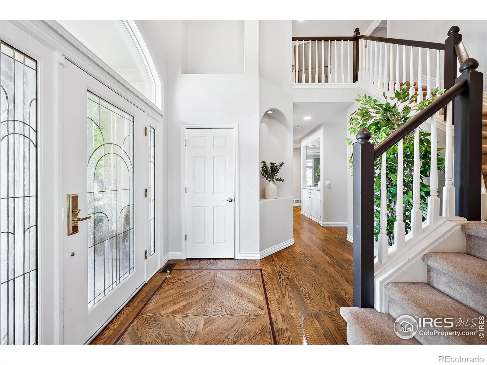 Beautiful custom home on a large, private 1/2 acre lot on quiet cul-de-sac with stunning mountain views and mature lush landscaping! Huge west facing wrap around deck w/plenty of room for grilling, dining and entertaining. Hardwood floors throughout the main level, formal and informal staircases leading to the upper level with 4 bedrooms and 3 bathrooms. Gourmet kitchen with large center island, slab countertops, custom backsplash, stainless appliances including 5 burner gas cooktop and warming drawer and eat in nook. Cozy family room with custom built-ins and stacked stone fireplace. The walk-out lower level has a guest bedroom and bathroom, a generous size recreation room with built in bar and media space and a bonus play room! Energy efficient with newly owned solar panels! Enjoy Colorado living at its best just steps from Indian Peaks Golf Course and community pool.