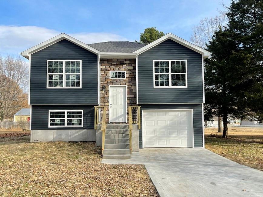 New-Build Home on South Side of El Dorado Springs: 
Be the first to own this vibrant, new-construction home in El Dorado Springs, Missouri located on a nice lot near the south edge of town.  The 3 bed, 2 bath contemporary, split-entry home with total 1630 sq ft will be completed in late summer/early fall 2025 and ready for its first occupant.  The home will feature slick finishes with an open concept on the main level, including vaulted ceilings and beautiful windows.  The main level also boasts 1017 sq ft including the living room, kitchen, 2 bedrooms, 1 bathroom, and a walk-out deck from the kitchen. In the kitchen there are custom wooden cabinets with granite countertops, making it a functional and attractive central hub of your home. The lower-level features 613 finished sq ft including a second living room, a bedroom, full bathroom, the utility room, plus the garage.  The exterior of the home features rock accents and sharp curb appeal.  Pictures of this home are from other homes that the builder has previously completed.  These pictures depict similar finishes to what will be available in this home; final color and design may vary from pictures. A buyer who puts this home under contract soon will have several color choices they may select from including siding, roof, gutter, trim, flooring, paint, cabinet stain, and granite. Call soon on this great opportunity for a brand-new home!!