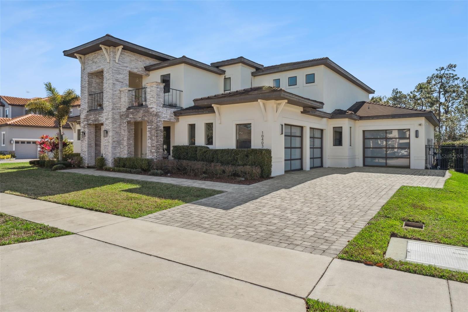 Welcome to this stunning lakefront five-bedroom residence, ideally situated in Water’s Edge at Lake Nona community within Northlake Park.From the moment you step inside, you’re greeted by soaring cathedral and vaulted ceilings that create an immediate sense of grandeur throughout this elegant two-story home. The open floor plan seamlessly connects the formal living and dining areas, flowing effortlessly into the kitchen and family room—perfect for both intimate gatherings and large-scale entertaining.The primary suite is conveniently located on the main level, offering a private retreat complete with a spacious walk-in closet. Four additional bedrooms and five and a half bathrooms provide ample space for family and guests, while the thoughtfully designed split-bedroom layout ensures comfort and privacy for all.Designed for both work and play, this home offers exceptional bonus spaces that elevate everyday living. A dedicated office creates an ideal work-from-home sanctuary, while the bonus room and private movie room invite relaxation and entertainment. High ceilings and abundant natural light enhance every inch of this nearly 5,000-square-foot masterpiece.Step outside to your own private oasis, where a sparkling in-ground pool and spa invite year-round enjoyment of Florida’s outdoor lifestyle. The beautifully landscaped garden and fire pit set the stage for unforgettable evenings under the stars, all with motorized boat access to Lake Nona just beyond your backyard.The location is equally impressive, offering easy access to Orlando International Airport, Highways 528 and 417, and just minutes from Lake Nona Town Center, Medical City, and the USTA National Campus. Nearby McCoy Community Park and the Lake Nona YMCA add even more convenience and recreational opportunities.Your dream home awaits—schedule your private showing today and experience the exceptional lakefront lifestyle this remarkable property offers!