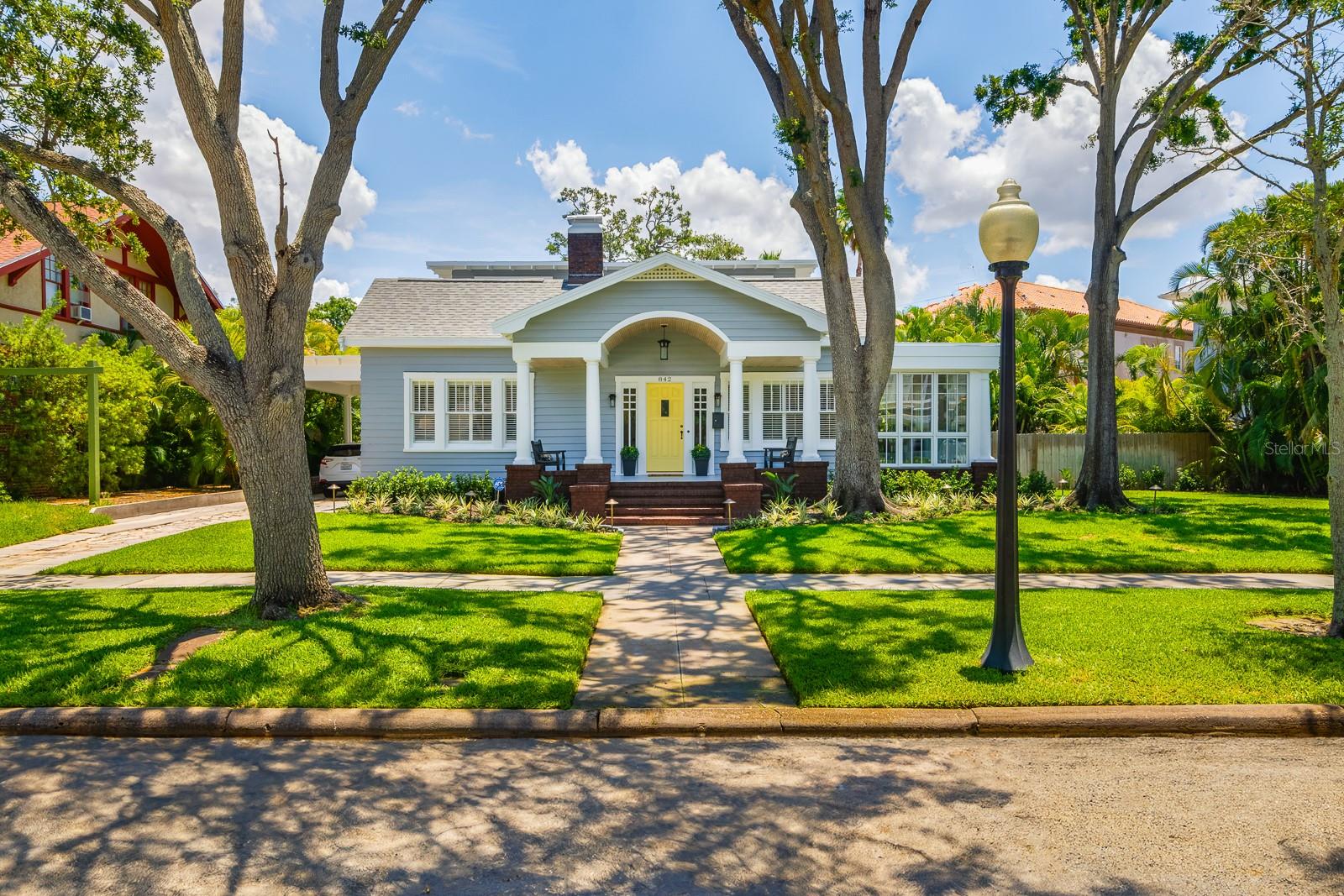 Under contract-accepting backup offers. Charming Elegance in Historic Hyde Park and just steps from the scenic Bayshore waterfront, this timeless residence blends classic charm with modern luxury. Situated on a large corner lot, the home welcomes you with gleaming hardwood floors, a grand living room adorned with crown molding, and a cozy wood-burning fireplace. The expansive dining room is ideal for hosting elegant dinners and gatherings. The chef’s kitchen is a true showstopper—featuring a Wolf gas range, SubZero refrigerator, quartz countertops, and a generous center island perfect for entertaining. The warm and inviting study with a gas fireplace and built-in shelving offers the perfect retreat for work or relaxation. Enjoy serene Bayshore water views from the all-glass Florida room with slate flooring. A large laundry room adds everyday convenience, while a full-size guest suite with en-suite bath on the first floor offers privacy and comfort. Upstairs, the owner’s suite boasts a luxurious en-suite bath and a spacious walk-in closet. A third well-appointed bedroom sits near a charming vintage-style hallway bath. (Main house features 3BR 3.5BA at 3,267SF plus the 1BR-1BA cottage at 380SF)The oversized one-car garage includes a private guest apartment above—ideal for visitors or additional income potential. All this, just a short stroll to the boutiques and cafés of Hyde Park Village, and a quick bike ride to Downtown Tampa and the Riverwalk. Virtual Matterport Tour: https://my.matterport.com/show/?m=2YeJgEC5q1n&mls=1