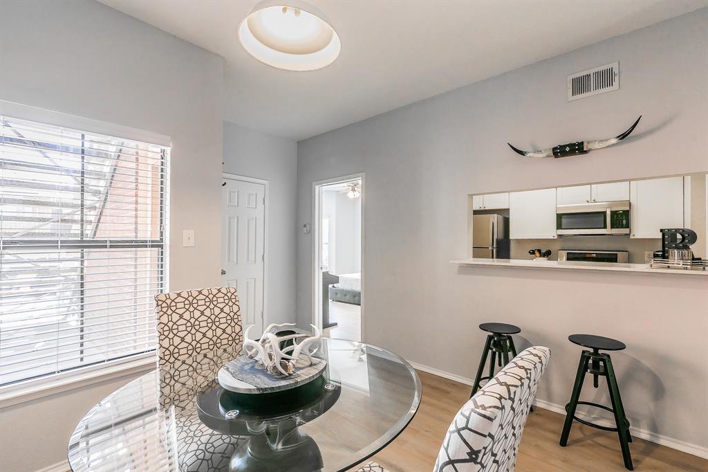 Near TCU!  Beautifully updated 2-bedroom, 2-bath condo in a highly sought-after community, perfectly positioned on the first floor with serene pool views. This move-in ready home features neutral paint tones and brand new white oak luxury vinyl plank flooring throughout. The inviting living room includes a cozy wood-burning fireplace and opens to a private balcony overlooking the pool—ideal for morning coffee or unwinding in the evenings.The kitchen is designed for both style and function with white cabinetry, stainless steel appliances, quartz countertops, and a breakfast bar that flows into the dining area. The spacious primary suite offers a bay window, large walk-in closet, and an en-suite bath with quartz countertops and updated 24x12 marble-style tile in the shower-tub combo. A split-bedroom layout provides privacy, with a generous second bedroom, its own walk-in closet, and a dedicated full bath with quartz countertops.Additional highlights include full-size washer and dryer, first-floor access, and rare dedicated covered parking.The community offers multiple pools, built-in BBQ areas, and a club room—perfect for a low-maintenance, lock-and-leave lifestyle. Ideally located in the Fort Worth entertainment district near Central Market, high-end shopping, restaurants, the hospital district, TCU, downtown, UNT Health Science Center, and the Cultural District. Quick access to Hwy 30 and University Drive makes commuting a breeze.A rare opportunity to own a first-floor, two-bedroom condo with designated covered parking in one of the most convenient and desirable areas of Fort Worth.  New Water Heater 2026.