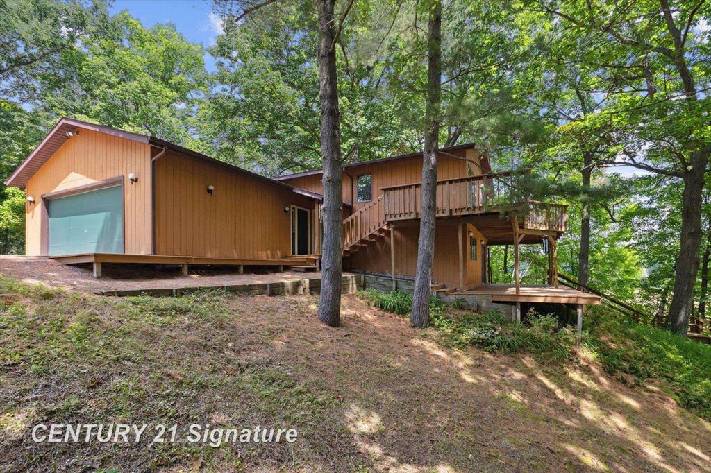 Life of Leisure on Lake Sanford Rd! The captivating view from the main floor of this expansive 2200 sq feet home with abundant views of the water from all of the windows is liberating! There are 2 bedrooms on the main level with the master having an entrance into the main bath from the bedroom near the walk in closet!  Conveniently the Laundry is on that floor as well just outside the bedroom in a closet in the hallway. This Desirable open floorplan makes entertaining a breeze especially with the full length wraparound deck with abundant views of the wildlife and water.  The lower level also has 2 more bedrooms and a full bathroom along with a GENEROUS family room that opens out to the patio under the decking above and also overlooking the water and woods. There is an attached 2 car garage with 220v and a detached 32x56 outbuilding with 12 ft ceilings, 220v, 2- 8 ft overhead doors, 1- 10 ft overhead door and natural gas in the shop all on a 1.13 acre parcel on Sanford lake