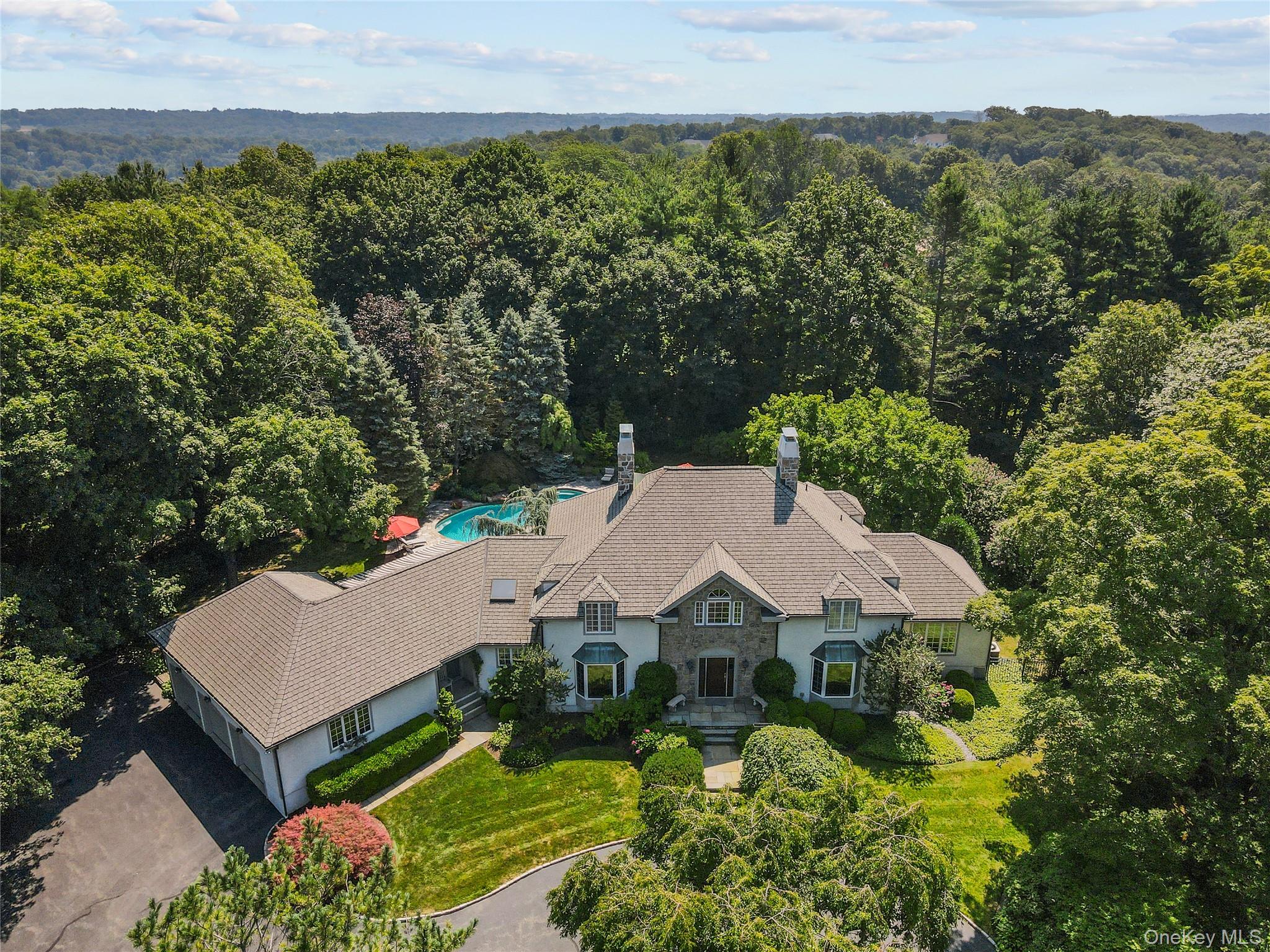 Elegant Living in the Heart of Armonk, NY. Set on a spectacular property with a pool and mature landscaping, including specimen plantings, this six-bedroom Colonial in the Byram Hills School District offers both elegance and everyday comfort. Designed for seamless indoor–outdoor living, the home features sunlit rooms, spacious living areas, and effortless flow to the patio and pool.The main level opens with a welcoming foyer, leading to a living room with doors to the patio and pool, a formal dining room, and an eat-in kitchen that connects to the family room. A first-floor primary suite with two walk-in closets and a generous bath provides a private retreat. An office, laundry room, two powder rooms, and garage access complete this level.Upstairs, five bedrooms and two hall baths offer versatility and space; the lower level extends the home with a study, full bath, two large finished storage areas, wine cellar, a fireplace, and additional unfinished storage.Outdoors is a private escape; a pool, a large patio, an outdoor dining area w/ built-in gas grill, and a level yard create the ideal setting for gatherings or quiet enjoyment. Just minutes from Armonk’s vibrant town center, this home blends convenience, luxury, and a sought-after Byram Hills school district.