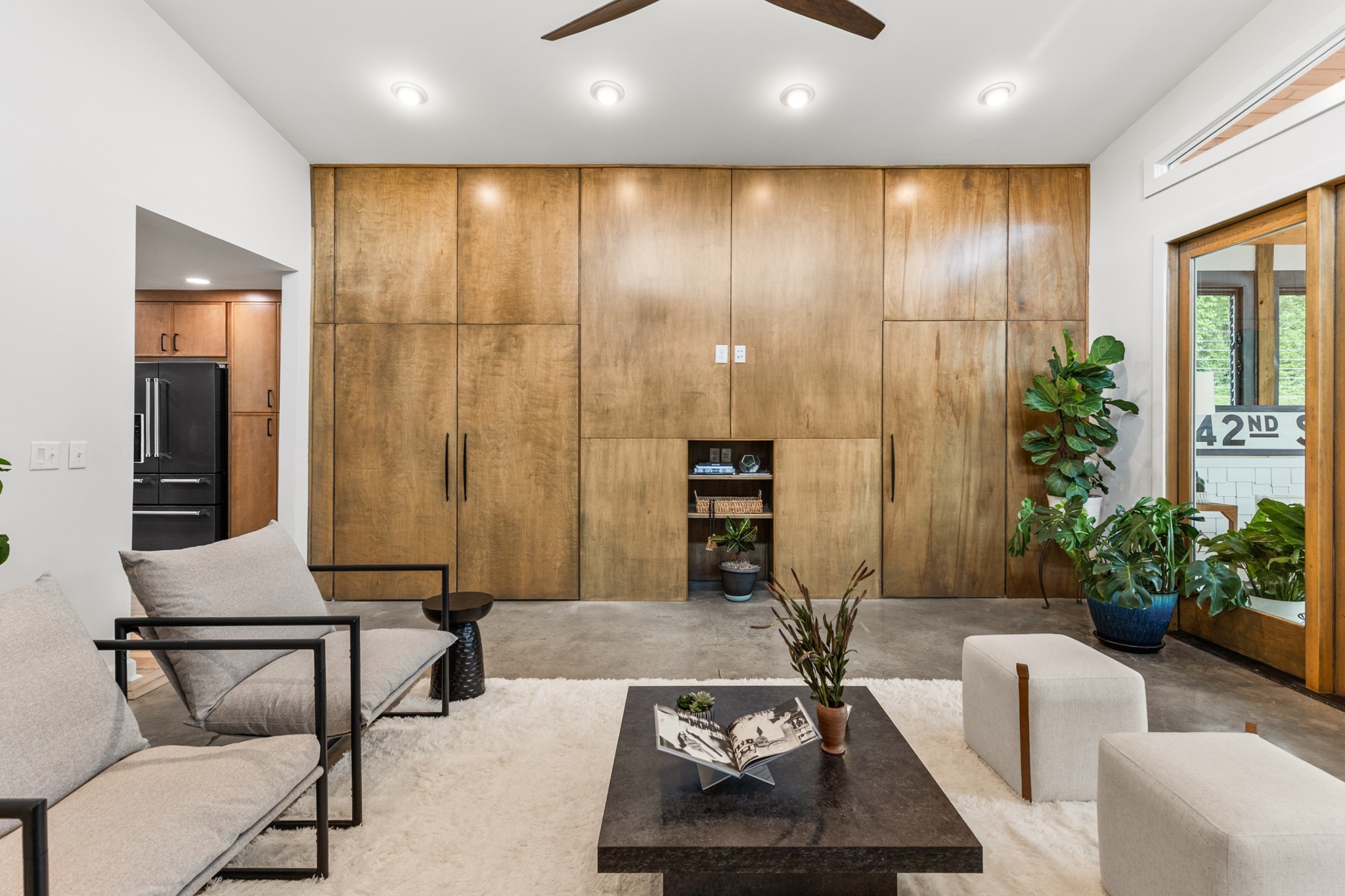 Your story begins at the striking green front door, framed by thoughtfully curated planters and sheltered by a magnificent mature tree. The new driveway & inviting wide steps create an immediate sense of arrival. Step inside to discover an open dining area that flows into a custom kitchen designed for both culinary creativity and meaningful conversation. Warm wood cabinets paired with stone tile and sleek black stainless appliances create a sophisticated yet approachable aesthetic. Two bedrooms and a full bath anchor the main living area. The private primary suite features dual closets, a spa-inspired bathroom, and direct access to a screened-in porch. The den serves as the heart of the home, connecting all spaces with polished concrete floors that add an industrial-chic touch. Built-in storage cleverly conceals the laundry and a half bath. Your oversized patio beckons with an outdoor fireplace—imagine hosting intimate gatherings or simply enjoying solitary moments under the stars. This seamless extension of your living space blurs the line between inside and out. Here's where dreams take flight: a climate-controlled 23' x 31' garage with retractable screen opens to reveal endless possibilities. Above, discover your private 23' x 25' studio space complete with a half bath and a full porch offering inspiring golf course views. Whether you're a painter, writer, musician, or entrepreneur, this dedicated creative sanctuary provides the space and separation you need to bring your vision to life. Quality schools serve the area, including Lockeland Elementary, Nashville Classical Charter School, Meigs Middle Magnet School, and East Nashville Magnet High School. Just one block away, Eastland's cultural pulse beats strong with beloved localgems like Rosepepper, Noko, TwoTen Jack, and enni's Ice Cream. You're not just buying a home—you're joining a community that celebrates creativity, authenticity, and the beautiful intersections of art and life. Ready to see inside?
