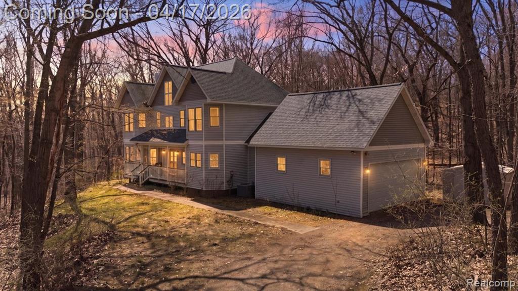 Welcome to 2222 S. Hickory Ridge Trail, where timeless charm meets peaceful, private surroundings. This 4-bed Milford home offers 2.5 baths, 2,600+ square feet, a bonus attic room, and sits on nearly 9 wooded acres with an attached garage and central AC. A welcoming front porch sets the tone, while multiple balconies offer elevated views of the wooded landscape and quiet spaces to relax. Inside, the home has been freshly painted and features newly finished hardwood floors and new carpet, creating a clean and updated feel throughout. Rich wood details add warmth and character across the home, while a cozy fireplace anchors the den or library, offering a perfect retreat for reading or quiet evenings. The kitchen has been refreshed with updated cabinetry and butcher block countertops, blending style and functionality. With 2,600+ square feet (not including the basement), the layout includes four bedrooms plus a versatile bonus attic room, and the convenience of second floor laundry. The walk-out basement is unfinished and ready to serve as a blank canvas, offering future potential for additional living space, recreation, or storage tailored to your needs. The property delivers privacy, natural beauty, and room to enjoy the outdoors. If you're searching for a home on acreage that blends charm, updates, and opportunity, this property stands out.