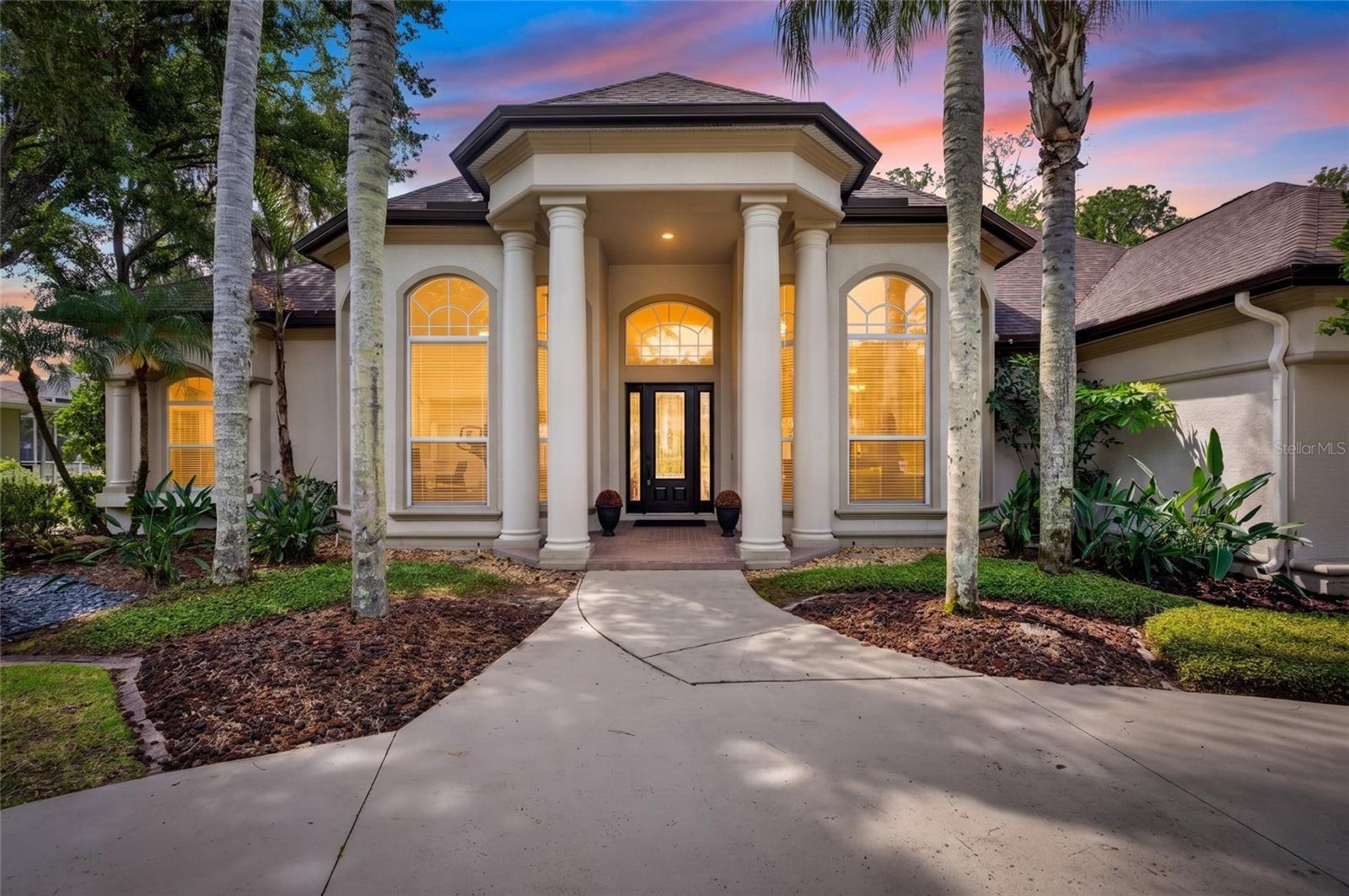 A beautiful secluded one story ranch sanctuary at The Reserve at Tampa Palms. This luxurious executive home, situated on nearly half an acre, beckons with its grandeur and meticulous design. High soaring ceilings grace the formal living and dining areas, leading you through a grand entrance to breathtaking views of the expansive screened lanai, oversized pool, and manicured gardens. Indulge in the spacious primary suite, complete with a home office for convenience. The kitchen, a chef's dream, boasts granite countertops, a built-in wall oven and warming drawer, a wine refrigerator, and a separate laundry room with ample pantry space and additional refrigerator. Cozy evenings await by the wood-burning fireplace. Recent updates include: roof 2021, HVAC unit 1 2024, HVAC Unit 2 2026, Hybrid water heater 2026, Master Suite 2024, Tesla charger, new accent TV wall and fresh interior new paint throughout and many other upgrades. The large salt water pool has a heated spa. The beautiful home offers total privacy with a 24-hour guarded community featuring a clubhouse and heated community pool, and easy access to a premier optional membership of Tampa Palms Golf Country Club. The community is also just moments way from the Flatwoods Wilderness Park with miles of trails. Ideally located minutes away from I-75 and I-275, University of South Florida, Busch Gardens, MOFFIT Cancer center, VA and Children’s Hospital, 25m to Downtown Tampa, 30m to Tampa International Airport. This north Tampa oasis is in a well established neighborhood with numerous restaurants, shopping and entertainment close-by, completed with vibrant business hubs of North Tampa. Don’t miss the rare opportunity to reside in one of Tampa’s most sought after communities and call this beautiful property your Florida home!