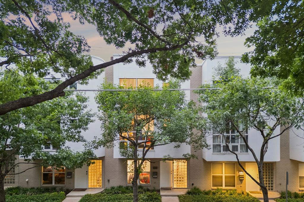 Architectural brilliance meets high-energy urban living in this AIA award-winning masterpiece by renowned architect Ron Wommack. Perfectly positioned in the heart of the Uptown-Knox corridor, this residence offers an unrivaled lifestyle just steps from the Katy Trail, Cole Park, and West Village. The interior is a celebration of light and scale, anchored by a dramatic two-story great room featuring exposed steel I-beams, hardwood floors, and a fireplace. The gourmet kitchen is a bold design statement, featuring high-gloss cobalt and white cabinetry, a striking textured mosaic backsplash, and a premium stainless appliance suite with a built-in wine cooler.The second-level primary suite serves as a serene retreat with a spa-inspired bath with a skylight illuminating the space. Crowned by a versatile third-floor loft—ideal for a home office or den—the home transitions seamlessly to a massive private rooftop deck. This outdoor oasis is protected by a custom permanent arched canopy with an integrated ceiling fan, creating the ultimate venue for year-round entertaining. Experience the pinnacle of design-forward living in one of Dallas' most walkable and vibrant neighborhoods.