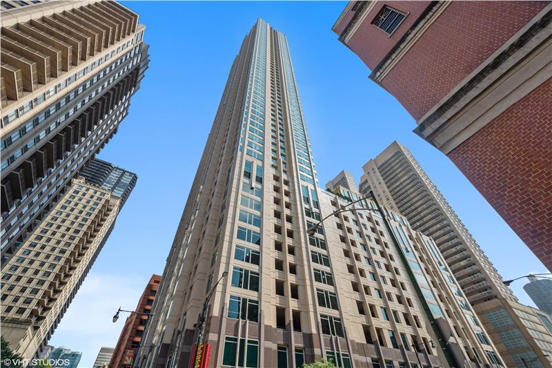 Meticulously maintained 2-bedroom in the heart of River North! This 40th floor enormous home features an expansive living area with plenty of room for a dining area, a cozy gas fireplace, a large wall of windows with extra-tall ceilings that enhance the sense of space. Each of the two bedrooms is generously sized and features its own walk-in closet. The open kitchen with high-end stainless-steel appliances features pristine maple cabinets which complement the generous island bar. And let's not forget about the crown jewel of this residence - the unparalleled views of the city skyline that stretches beyond the neighboring buildings, offering a panoramic view of the skyline offering the ever-changing tapestry of city lights. 33 Ontario is a Full Service, Full Amenity high rise with an outdoor swimming pool, fitness center, 24hr attentive door staff, resident lounge, party room, bike storage & package delivery to your door. Exciting River North location; steps to everything including the Mag Mile, the Riverwalk, beach, running/bike path, 3 grocery stores (Whole Foods, Trader Joe's, Jewel), parks, museums, cafes, theaters. Public transport outside your door, easy access to expressways. All-inclusive assessment includes internet, cable, heating, air conditioning, gas. Extremely well run and organized HOA with professional on-site management. Parking available to rent or purchase in attached garage. Walk Score 100
