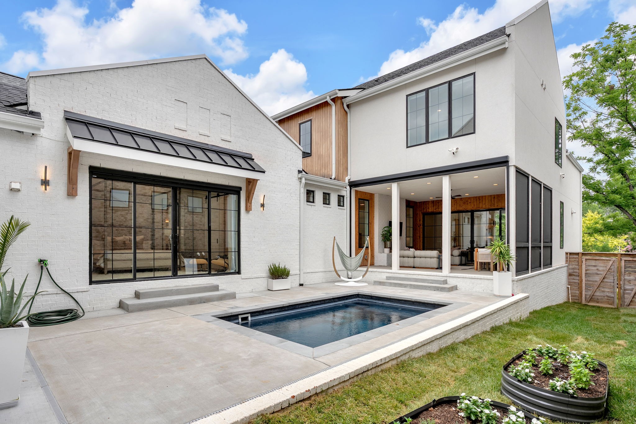 Tucked along one of the most iconic and desirable streets in Shelby Hills, this architecturally stunning home on Electric Avenue is more than a luxury residence—it’s your front-row seat to East Nashville’s walkable lifestyle, thoughtful design, & unmistakable character. ***Just steps from Lockeland Table, Frothy Monkey, Urban Cowboy, East Hill Work Club, & Shelby Commons, it’s surrounded by the neighborhood’s most beloved spots. From block parties at Roy’s Meat Service to concerts at Cornelia Fort & the charm of the Robot Parade, this area blends creativity and community like nowhere else. Just one block away, Shelby Park offers two golf courses, a disc golf course, and endless recreation—tennis, pickleball, volleyball, soccer, skating, & miles of walking and biking trails. Families will also appreciate that this home is priority zoned for Lockeland Design Center—one of the top-ranked elementary schools in TN.***Purposefully designed for comfort and connection, this 5-bedroom, 4.5-bath home offers effortless indoor-outdoor living. The main living space opens to a covered patio with electric retractable screens that block 85% of UV rays and keep the space cool—ideal for Nashville summers. A heated resistance pool, indoor/outdoor gas fireplace, and direct access from the primary suite create a private retreat for entertaining or relaxing. ****The kitchen impresses with vaulted ceilings, exposed beams, designer lighting, Thermador appliances, and a Bertazzoni Italian gas range. Elevated touches include a rare Noguchi Akari pendant, custom California Closets, three laundry areas, a gallery-style hallway w/ integrated art lighting, & a storm shelter. The bonus suite—with private entrance, HVAC, & kitchenette—offers flexibility for guests, remote work, or STR use. Smart home features, a Generac generator, & an 8-ft privacy fence with gated entry complete the package. ****Schedule your private showing and discover a home—and a lifestyle—crafted to exceed expectations.