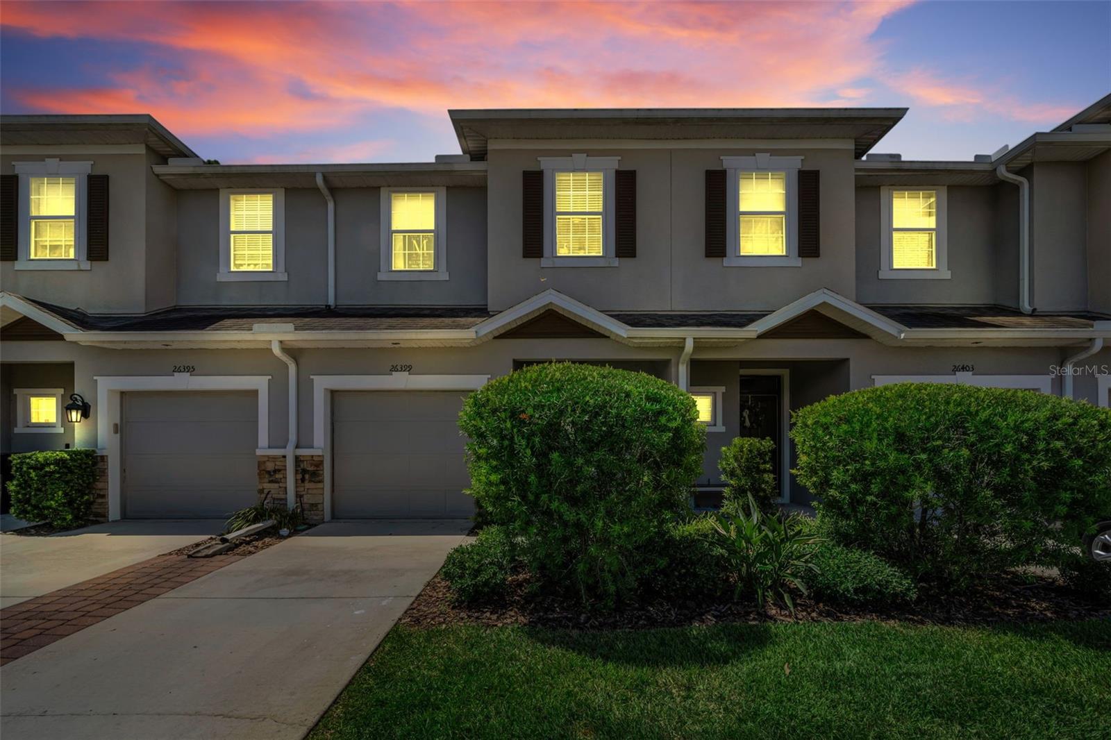 Welcome home to this beautifully upgraded 3-bedroom, 2.5-bath townhome that blends modern comfort with timeless style. From the moment you step inside, you’ll be greeted by an open-concept floor plan filled with natural light and elegant finishes throughout. The spacious living area features upgraded flooring, recessed lighting, peaceful, private view—perfect for relaxing or entertaining. The Stunning chef’s kitchen boasts upgraded finishes, large overhang breakfast bar, stainless steel appliances, under mounted sink, top tier granite countertops, designer glass tile backsplash, 42 inch cabinetry, and cabinet under lighting! Upstairs, the primary suite offers a tranquil retreat complete with a walk-in closet and a spa-inspired ensuite bath featuring dual vanities and a glass-enclosed shower. Two additional bedrooms share a well-appointed full bath, while a convenient upstairs laundry room adds everyday ease. The stairs and second floor have been upgraded with WOOD and LUXURY Vinyl Flooring (2025). Enjoy your morning coffee or evening unwind on the private patio overlooking lush greenery—no rear neighbors for added privacy. Additional highlights include a finished garage with Epoxy glazed flooring, NEW Whole House Dehumidifier and Halo Air Purification System. Low HOA fee, with NO CDD fee, includes full-service lawn maintenance, water, trash, playground, and community reserves. The location of the home is in close proximity to Wiregrass, The Tampa Premium Outlets, Medical, Restaurants, & Entertainment! Schedule your showing today!!
