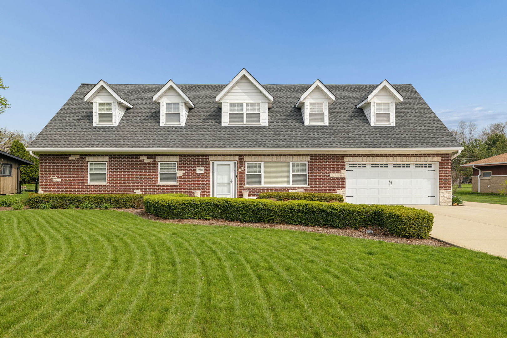 Prepare to be amazed by this all-brick, truly remarkable home perfectly situated on a quiet, mature street in unincorporated Lockport. Meticulously maintained with an unmatched attention to detail, this home stands out from the moment you arrive. The main level offers a spacious, open floor plan that is both functional and inviting, filled with natural light and finished with real hardwood floors that continue throughout both levels of the home. The living area features a cozy electric fireplace with stunning custom built-ins, creating a warm and elevated focal point. The kitchen is a true showpiece, complete with high-quality custom cabinetry, granite countertops, an oversized eat-in island, and a separate dining area-perfect for everyday living and entertaining. The main level primary suite is a private retreat, featuring a beautifully designed en suite bathroom with a jacuzzi tub, separate glass and tile walk-in shower, and thoughtful finishes throughout. A convenient first-floor laundry room is located just off the garage, along with a stylish half bath. One of the most unique features of the home is the cedar-lined dual closet with custom built-ins and granite countertops-both functional and impressive. Upstairs, you'll find a versatile second living space that can easily serve as a family room, playroom, office, or flex space to fit your needs. Two generously sized bedrooms offer custom closets with built-ins and ample storage. The second full bathroom is equally impressive, featuring a soaking tub, separate Corian walk-in shower, and double vanity. Step outside to a fully fenced backyard that feels like your own private retreat. The expansive brick paver patio, custom brick fireplace with granite tops, and serene pond with waterfall create the perfect setting for entertaining or relaxing. Natural gas grill and a storage shed adds even more functionality to the outdoor space - plus a WHOLE HOUSE GENERATOR! The attached garage is finished with epoxy flooring and includes built-in storage cabinets, a sink, fridge, and convenient side door access. The extra-wide driveway features an additional concrete parking pad alongside the garage-ideal for extra vehicles, a boat, or RV. A clean and easily accessible 3-foot concrete crawl space provides even more storage options. Ideally located with close proximity to shopping, dining, and entertainment in both Lockport and Lemont, with easy access to I-355, nearby golf courses, and forest preserves-this location truly offers the best of everything. Between the quality of the home and the unbeatable location, this is one you won't want to miss.