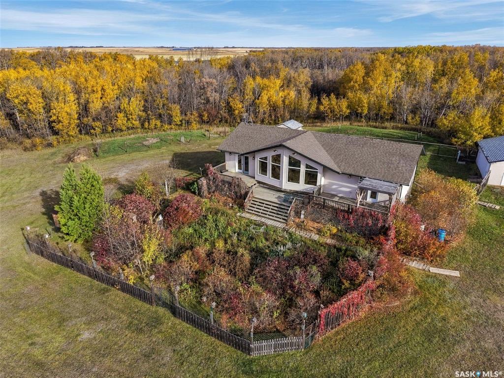 Welcome to a piece of prairie paradise near Pike Lake and the South Saskatchewan River Valley. If you are wanting to make the move to an acreage out in the country and still a quick 20 minute drive into Saskatoon, this acreage has plenty to offer. Sitting on  80 acres with gently sloping grassland, the acreage includes a large bungalow house, a double detached garage, an oversized single garage that is heated and insulated, plus a planting shed, small greenhouse, and a few other outbuildings and some fenced areas for animals. Inside the house, enjoy the abundance of natural light, vaulted ceiling in the living room, and good sized rooms on the main level. The kitchen has an island, corner pantry and lots of counter space. The dining area, kitchen and living room are open concept and offer great views of the countryside. The mudroom and access to the back yard includes a main floor laundry area. There are 3 bedrooms and 2 bathrooms on the main floor. The perimeter walls in the basement are insulated and windows are above grade. Gardeners will enjoy having a cold storage room. There is a 4th bedroom in the basement plus a rough-in for a future bathroom. This acreage offers plenty of space. Check out a video for this property by copying this link on your browser: https://youtu.be/yXXd5rIcdf8This is a presentation of offers sale with offers presented to the Sellers at 8 p.m. on Tuesday, October 27, 2026.