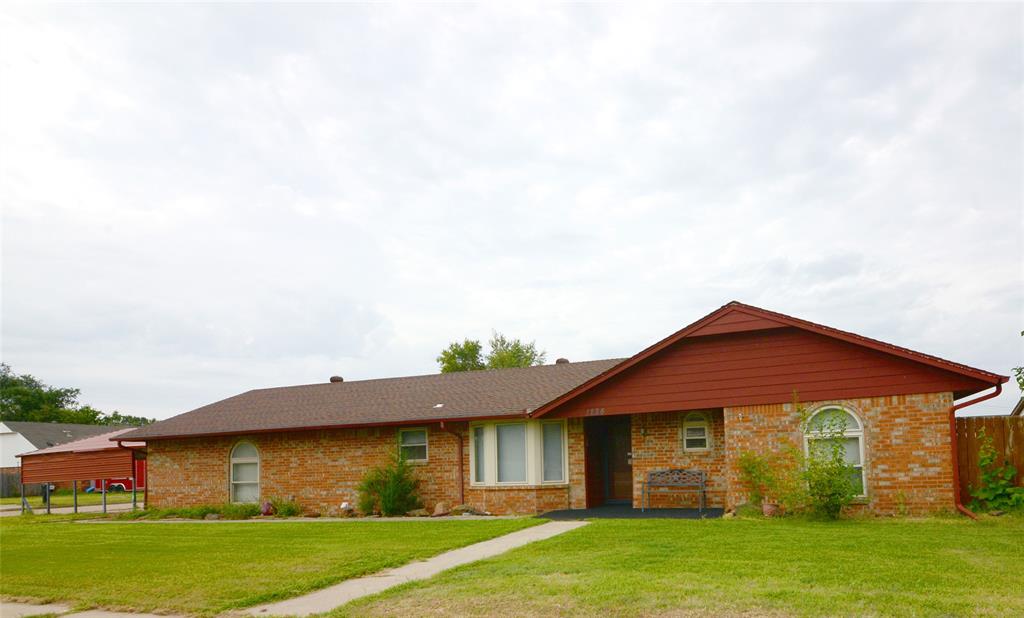 This perfect home on a corner lot is located within walking distance to Santa Fe Elementary and Highland West Junior High; and for the growing families, there is a full playground in the neighborhood. The home features laminate flooring in the entry, hallway, living room, and one secondary bedroom. Both the living room and the secondary bedroom have custom rungs which will stay with the house. All windows have shades or blinds for privacy. Other interior features include a tile shower in the primary suite and tub surround with sliding mirrored shower door in the hall bath. There is a wood burning fireplace in the living area to bring joy and comfort to those winter nights. Outside, your family will find a covered patio for all your outdoor entertainment, and also, a concrete above ground storm shelter and a storage shed to house lawn equipment. There is a sprinkler system in front yard. The large garage has many built in shelves for storage. The house also boasts an additional concrete parking space for third car and a two-car carport. A new HVAC/Heat pump was installed in 2021.