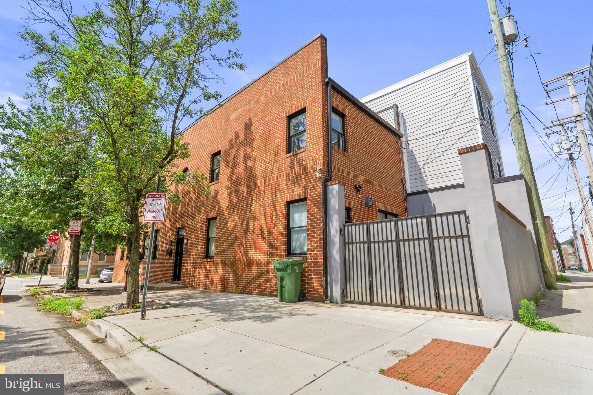 Experience modern living at its finest in this contemporary corner-block home, designed with sleek architecture and thoughtful finishes throughout. From its striking brick exterior to its inviting open spaces, this residence combines comfort, functionality, and style.Step inside and you’re greeted with a spacious open layout, elevated living area, and tall windows that flood the home with natural light. The sleek LVP flooring and neutral tones set a modern, timeless backdrop. The living room features a stylish fireplace and dual-level design, one area for relaxing with a sofa and television, and a lower space perfect for entertaining.At the heart of the home lies a stunning hot tub room, fully enclosed in glass with a ceiling that soars to the top floor. This striking centerpiece blends luxury and architecture, creating an eye-catching focal point visible from multiple areas of the home. Whether for relaxation or entertaining, it offers a spa-like atmosphere in the comfort of your own living space.The gourmet kitchen is a chef’s dream, featuring tiled flooring, a mix of black, white, and stainless steel finishes, modern cabinetry, and a tiled backsplash. A large window over the sink fills the space with sunlight, while premium appliances including refrigerator, wine chiller, oven, microwave, cooktop, and dishwasher make hosting effortless. A breakfast bar and pantry add both style and functionality.Upstairs, you’ll find three spacious bedrooms, each designed with comfort in mind. The primary suite includes its own spa-inspired bathroom with dual sinks, a walk-in rain shower with dual shower heads, and ample cabinetry. Additional bedrooms offer airy, light-filled retreats, with one overlooking the dramatic glass-enclosed hot tub room below. Bathrooms feature tiled finishes, soaking tubs, and modern vanities.The finished basement extends the living space further, featuring a fourth bedroom that provides flexibility for guests, a private office, or an additional family space.A laundry room with washer and dryer, and a private backyard with gated access that can fit one vehicle is a plus for this property. The expansive rooftop deck provides the perfect space to relax or entertain while enjoying neighborhood views.Street parking is available, and pets are welcome with a pet addendum and a $500 non-refundable fee.Nearby Landmarks & Attractions:Patterson Park – 3 min walkCanton Waterfront Park & Promenade – 6 min driveThe Shops and Restaurants of Canton Square – 4 min driveJohns Hopkins Bayview Medical Center – 10 min driveFells Point Historic District – 8 min driveAgency disclosed upon initial contact. Agent conducts showings; BMG manages follow-up, paperwork, move-in post-approval. Vouchers work with BMG directly.